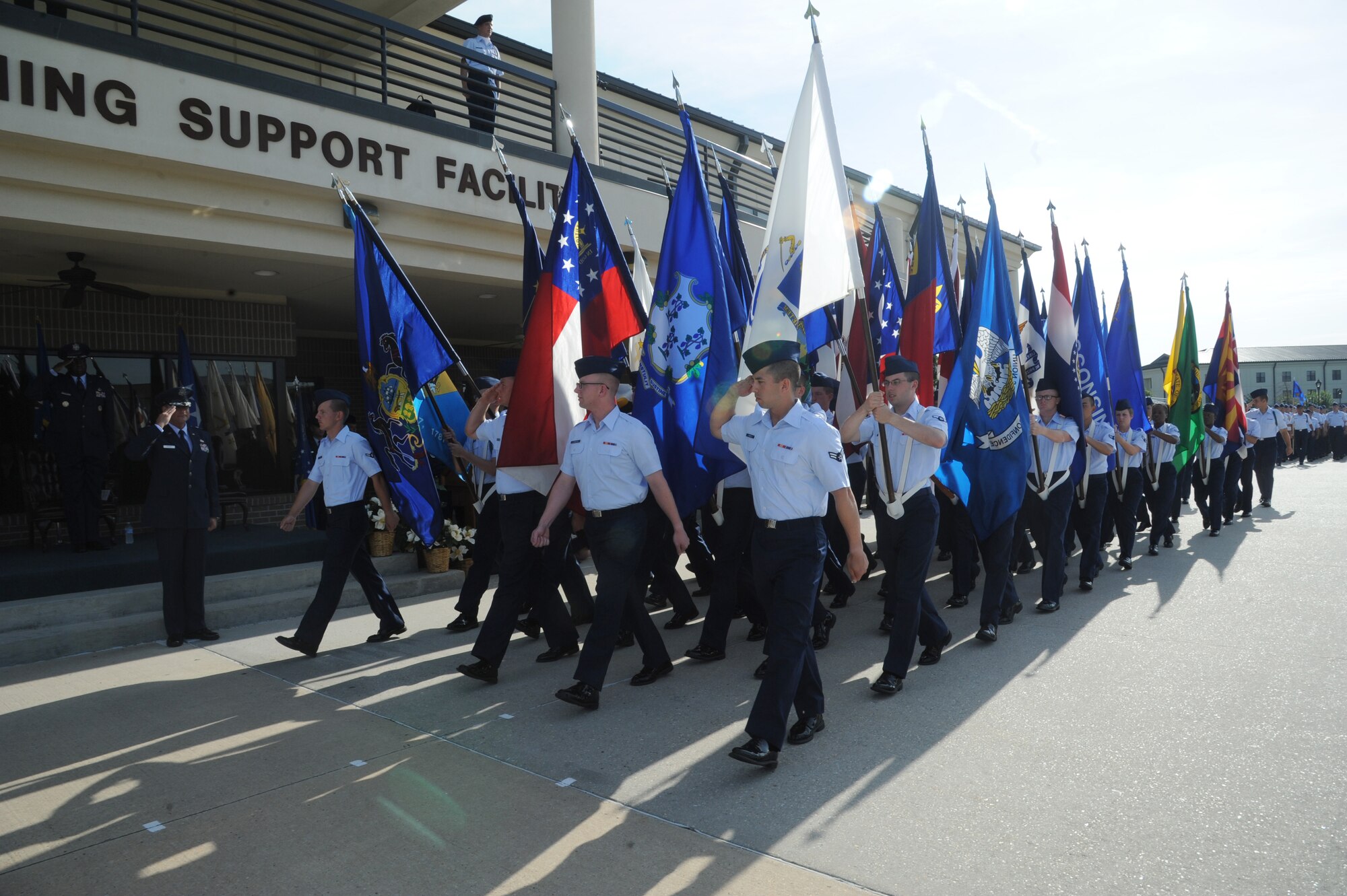 Maj. Gen. Leonard Patrick, outgoing 2nd Air Force commander, renders a salute as the 50-state flag team march during pass and review following the 2nd Air Force change of command ceremony July 3, 2014, at Keesler Air Force Base, Miss.  Patrick is replaced by Brig. Gen. Mark Brown who was previously the Financial Management director, Headquarters Air Force Material Command at Wright-Patterson Air Force Base, Ohio. (U.S. Air Force photo by Kemberly Groue)