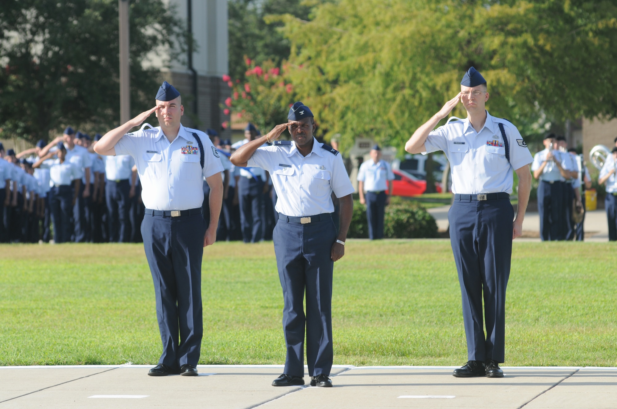 Tech. Sgt. Kyle Mullen, 81st Training Group; Col. Malcolm Johnson, 2nd Air Force vice commander, and Staff Sgt. Micah Blanton, 2nd Air Force, render a salute as the national anthem is played during the 2nd Air Force change of command ceremony July 3, 2014, at Keesler Air Force Base, Miss. Brig. Gen. Mark Brown assumed command at the ceremony from Maj. Gen. Leonard Patrick. Brown was previously the Financial Management director, Headquarters Air Force Material Command at Wright-Patterson Air Force Base, Ohio. Patrick is headed to Randolph Air Force Base, Texas, where he will become the AETC vice commander.  (U.S. Air Force photo by Kemberly Groue)
