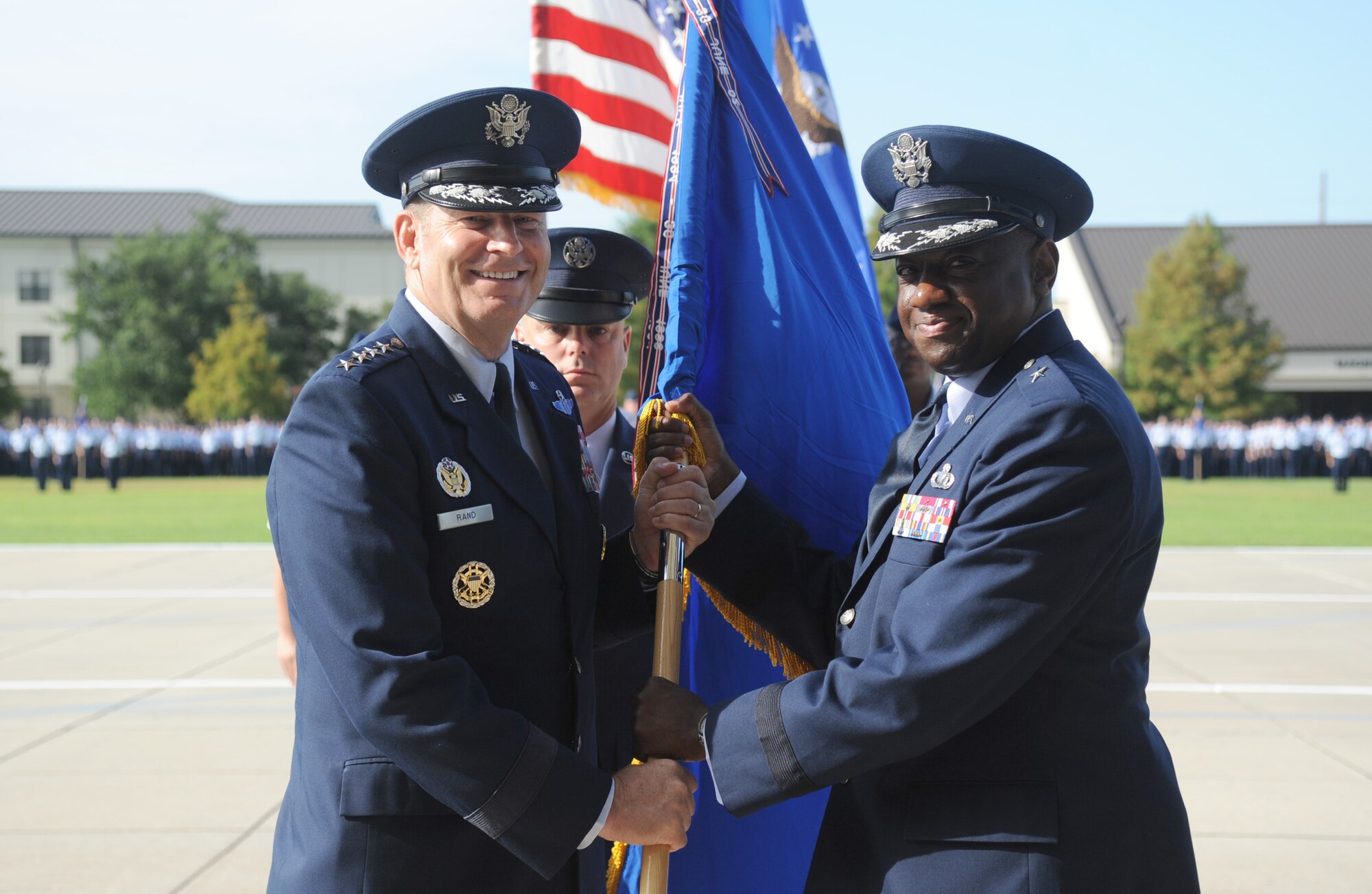 Gen. Robin Rand, left, commander of Air Education and Training Command, passes the 2nd Air Force flag to Brig. Gen. Mark Brown, new commander, as Chief Master Sgt. David Staton, 2nd Air Force command chief, looks on during the 2nd Air Force change of command ceremony July 3, 2014, at Keesler Air Force Base, Mississippi. Brown was previously the Financial Management director, Headquarters Air Force Material Command at Wright-Patterson Air Force Base, Ohio. He replaces Maj. Gen. Leonard Patrick, who's headed to Joint Base San Antonio-Randolph, Texas, where he will become the AETC vice commander. (U.S. Air Force photo by Kemberly Groue)