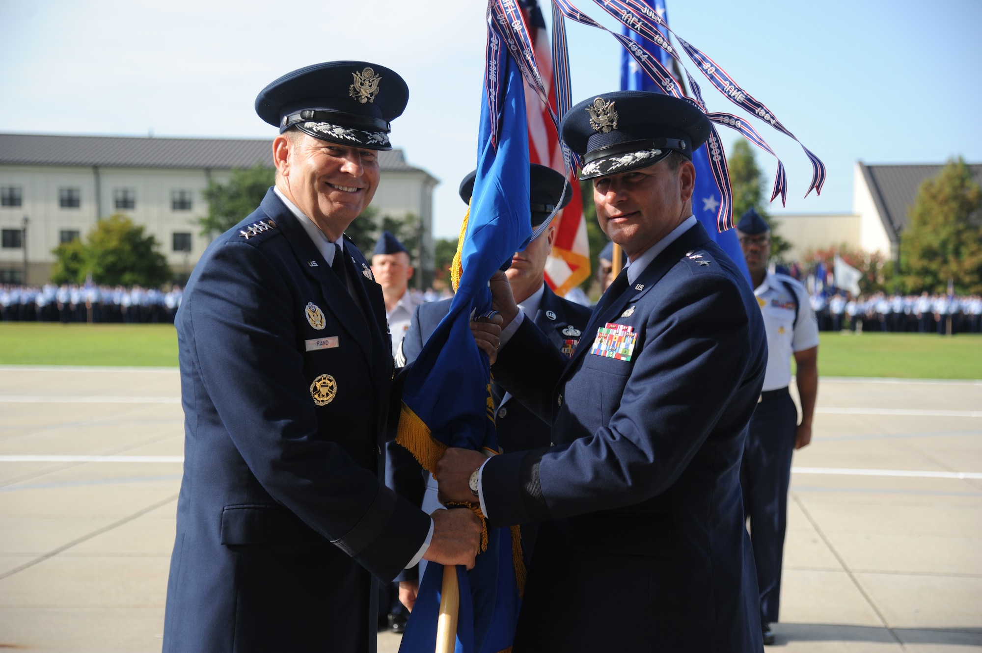 Gen. Robin Rand, left, commander of Air Education and Training Command, receives the 2nd Air Force flag from Maj. Gen. Leonard Patrick, outgoing commander, during the 2nd Air Force change of command ceremony July 3, 2014, at Keesler Air Force Base, Mississippi. Patrick, who will become the AETC vice commander at Joint Base San Antonio-Randolph, Texas, is replaced by Brig. Gen. Mark Brown. (U.S. Air Force photo by Kemberly Groue)