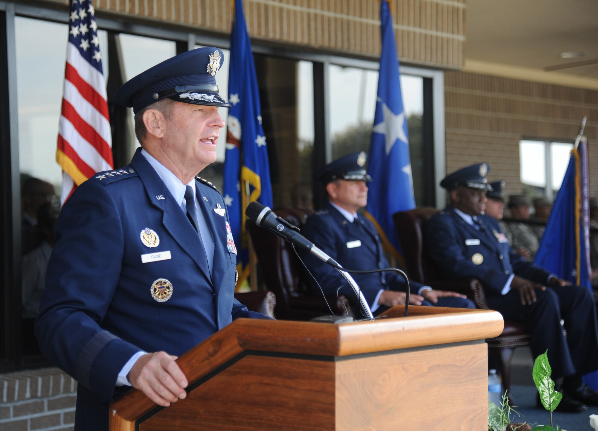 Gen. Robin Rand, commander of Air Education and Training Command, delivers remarks during the 2nd Air Force change of command ceremony July 3, 2014, at Keesler Air Force Base, Mississippi, as Maj. Gen. Leonard Patrick, outgoing 2nd Air Force commander, and Brig. Gen. Mark Brown, incoming commander, look on.  Patrick is headed to Joint Base San Antonio-Randolph, Texas, where he will become the AETC vice commander. Brown was previously the Financial Management director, Headquarters Air Force Material Command at Wright-Patterson Air Force Base, Ohio. (U.S. Air Force photo by Kemberly Groue)