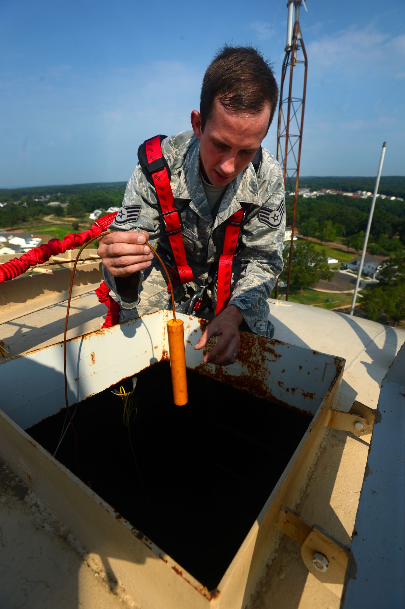 U.S. Air Force Staff Sgt. Phillip Coley, 20th Civil Engineer Squadron water and fuels systems maintenance craftsman, completes inspects the cathodic protection inside of a water tower at Shaw Air Force Base, S.C., July 8, 2014. Cathodic protection controls the metal corrosion of the 250,000 gallon water tower. (U.S. Air Force photo by Airman 1st Class Jensen Stidham/Released)