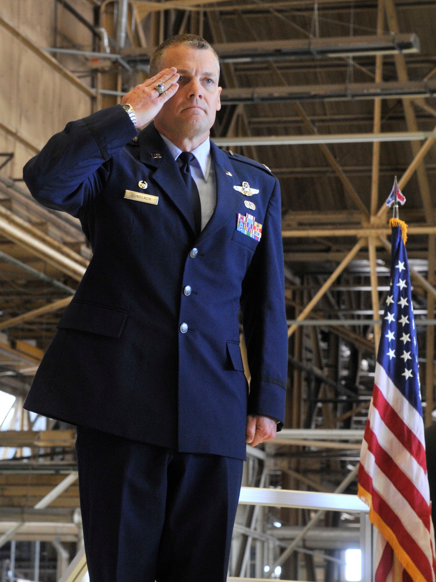 Col. Scott Gundlach renders a salute during a change of command ceremony at Fairchild Air Force Base, Washington, July 8, 2014. Gundlach took command of the 92nd Operations Group during the ceremony and previously served as the executive assistant to the commander, U.S. Transportation Command at Scott AFB, Illinois. He hails from Denison, Texas. (U.S. Air Force photo by Senior Airman Mary O'Dell/Released)