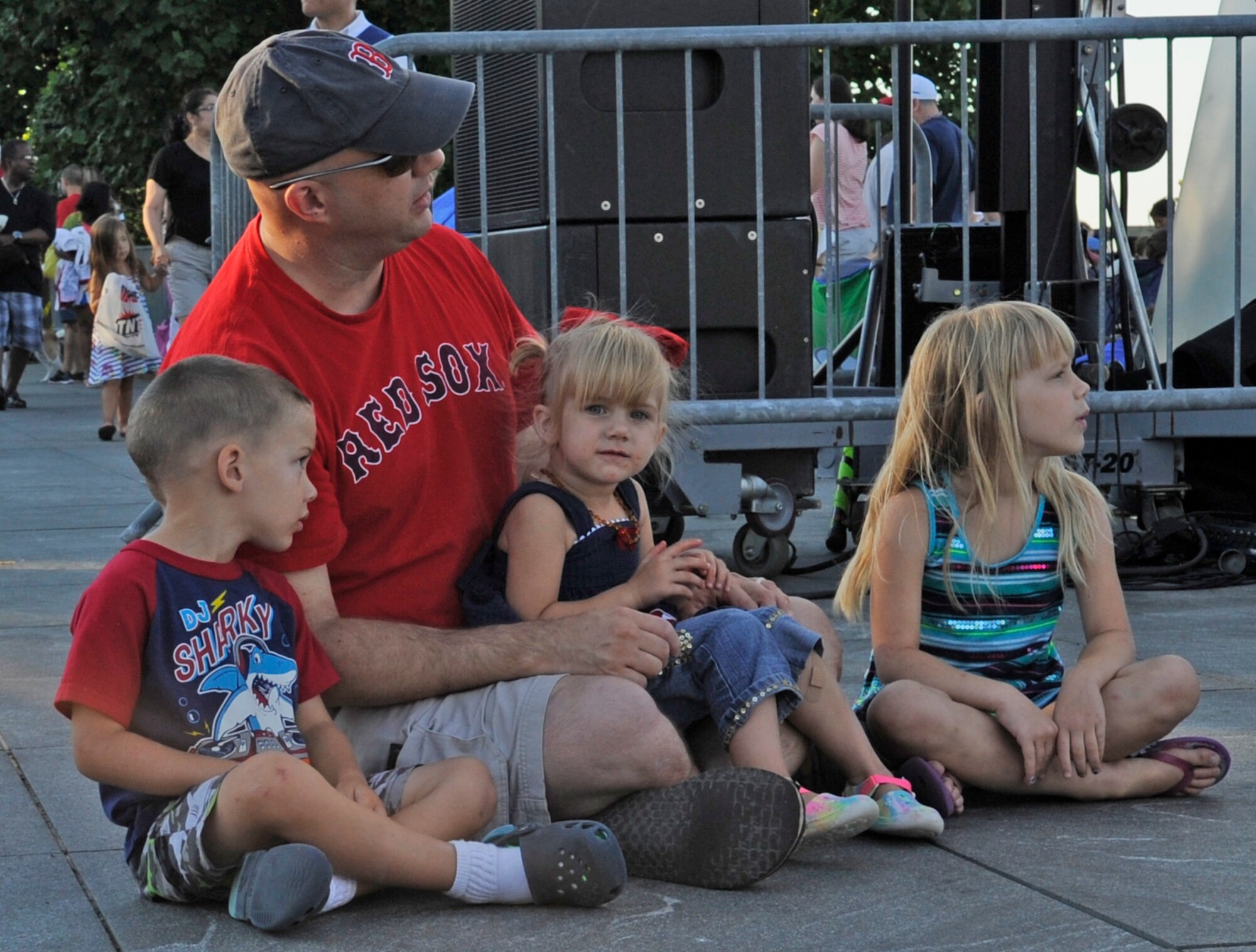 Capt. David Alpar and his children Charles (left), Violet and Phoebe watch the United States Air Force Concert Band and Singing Sergeants perform at the Air Force Memorial, July 4, 2014,  during an Independence Day Concert.  Alpar is the USAF Band's assistant director of operations. (U.S. Air Force photo/ Senior Airman Mariah Haddenham)