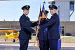 Col. Matthew C. Isler, 12th Flying Training Wing commander, left, presents Col. Steve Burgh, 306th Flying Training Group commander, with the 306th Flying Training Group guidon during a Change of Command Ceremony July 3, 2014.  Changes of command are a military tradition representing the transfer of responsibilities from the presiding officials to the upcoming official.  (U.S. Air Force Photo by Elizabeth Copan)