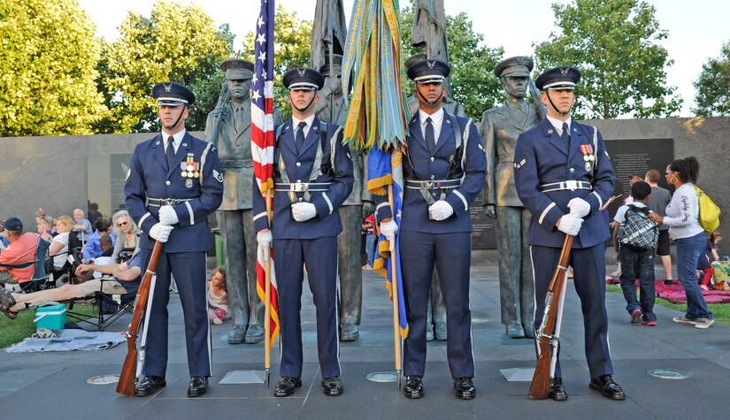 Members of The United States Air Force Honor Guard's Colors Element prepare to post the colors at the Air Force Memorial on July 4, 2014, during USAF Band's Independence Day Concert.  After the performances, attendees viewed the National Fireworks Show. (U.S. Air Force photo/ Senior Airman Mariah Haddenham)