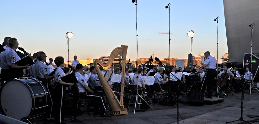 The United States Air Force Concert Band and Singing Sergeants perform at the Air Force Memorial on July 4, 2014, to celebrate Independence Day. After the performances, attendees viewed the National Fireworks Show. (U.S. Air Force photo/ Senior Airman Mariah Haddenham)