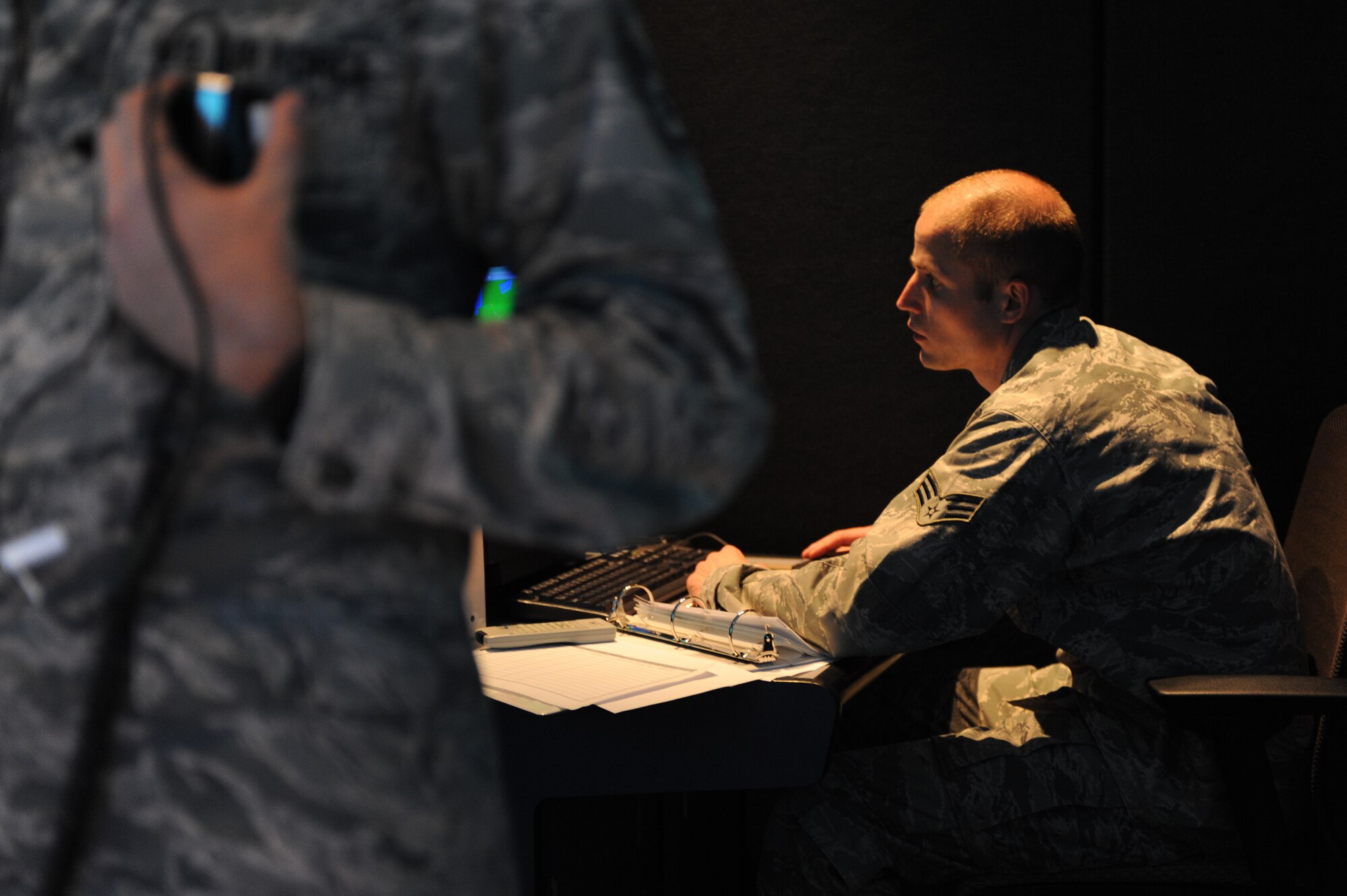Senior Airman Patrick Lura, 5th Operations Support Squadron air traffic control journeyman, assists Staff Sgt. Joshua Kimball, 5th OSS ATC apprentice, during flight simulator training on Minot Air Force Base, N.D., May 20, 2014. The current lull in operations, due to runway construction, has allowed Minot’s ATCs to refocus on training. (U.S. Air Force photo/Senior Airman Stephanie Morris)