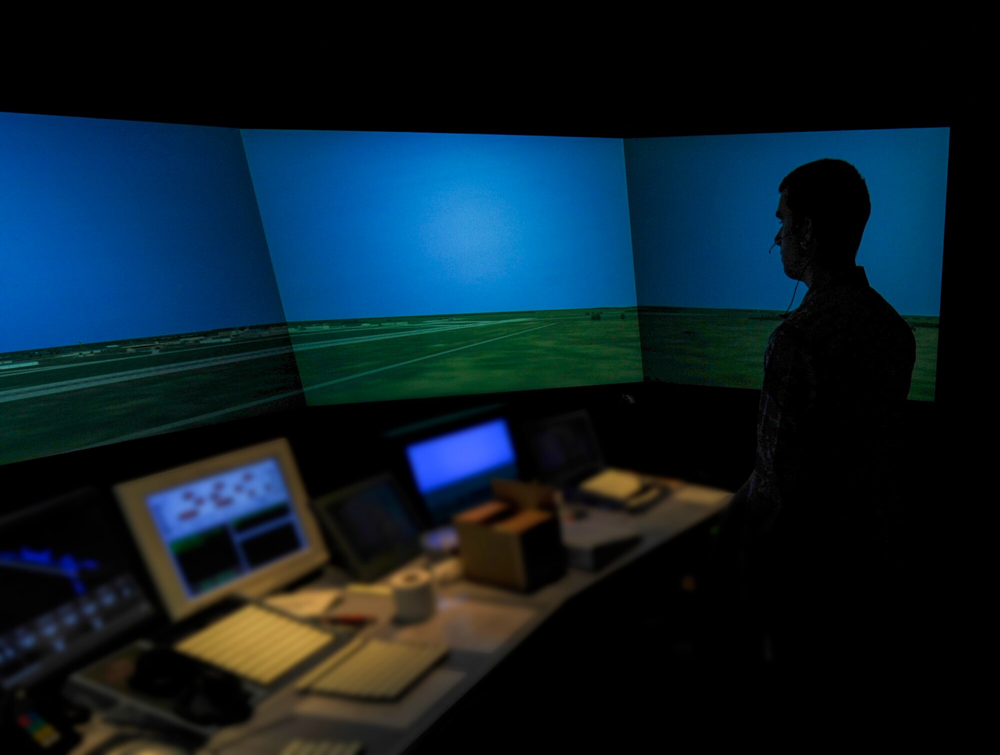Staff Sgt. Joshua Kimball, 5th Operations Support Squadron air traffic control apprentice, uses a flight simulator in the control tower, on Minot Air Force Base, N.D., May 20, 2014. The simulator uses a variety of scenarios for take-offs and landings that allow ATCs to practice without endangering equipment or personnel. (U.S. Air Force photo/Senior Airman Stephanie Morris)