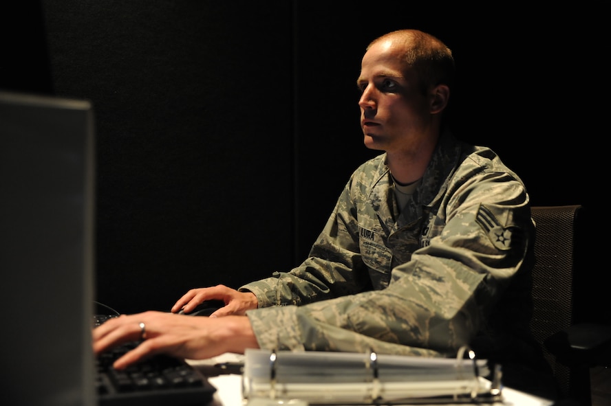 Senior Airman Patrick Lura, 5th Operations Support Squadron air traffic control journeyman, starts up a flight simulator on Minot Air Force Base, N.D., May 20, 2014. The simulator is used to train ATCs on the proper procedures for take-offs and landings without endangering equipment or personnel. (U.S. Air Force photo/Senior Airman Stephanie Morris)