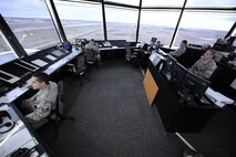 5th Operations Support Squadron air traffic controllers monitor the flight line from the control tower on Minot Air Force Base, N.D., May 20, 2014. ATCs are in constant communication with both pilots and ground crew to ensure the safety of aircraft during taxi, take-off, and landing. (U.S. Air Force photo/Senior Airman Stephanie Morris)