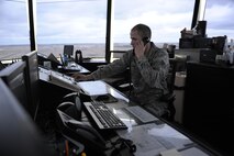 Senior Airman Patrick Lura, 5th Operations Support Squadron air traffic control journeyman, answers a call in the control tower on Minot Air Force Base, N.D., May 20, 2014. The tower is in constant communication with both pilots and ground crew to ensure the safety of Aircraft during taxi, take-off, and landing. (U.S. Air Force photo/Senior Airman Stephanie Morris)