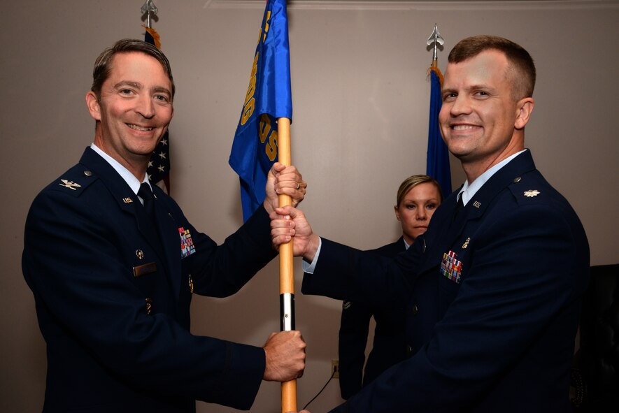 U.S. Air Force Lt. Col. (Dr.) John Davis, 20th Dental Squadron commander, receives the 20th DS guidon from Col. Kurt Prichard, 20th Medical Group commander, at Shaw Air Force Base, S.C., July 8, 2014. Davis assumed command of the squadron after a tour as the dental support programs manager at Air Force Medical Operations Agency at Joint Base San Antonio Lackland, Texas. (U.S. Air Force photo by Airman 1st Class Jonathan Bass/Released)