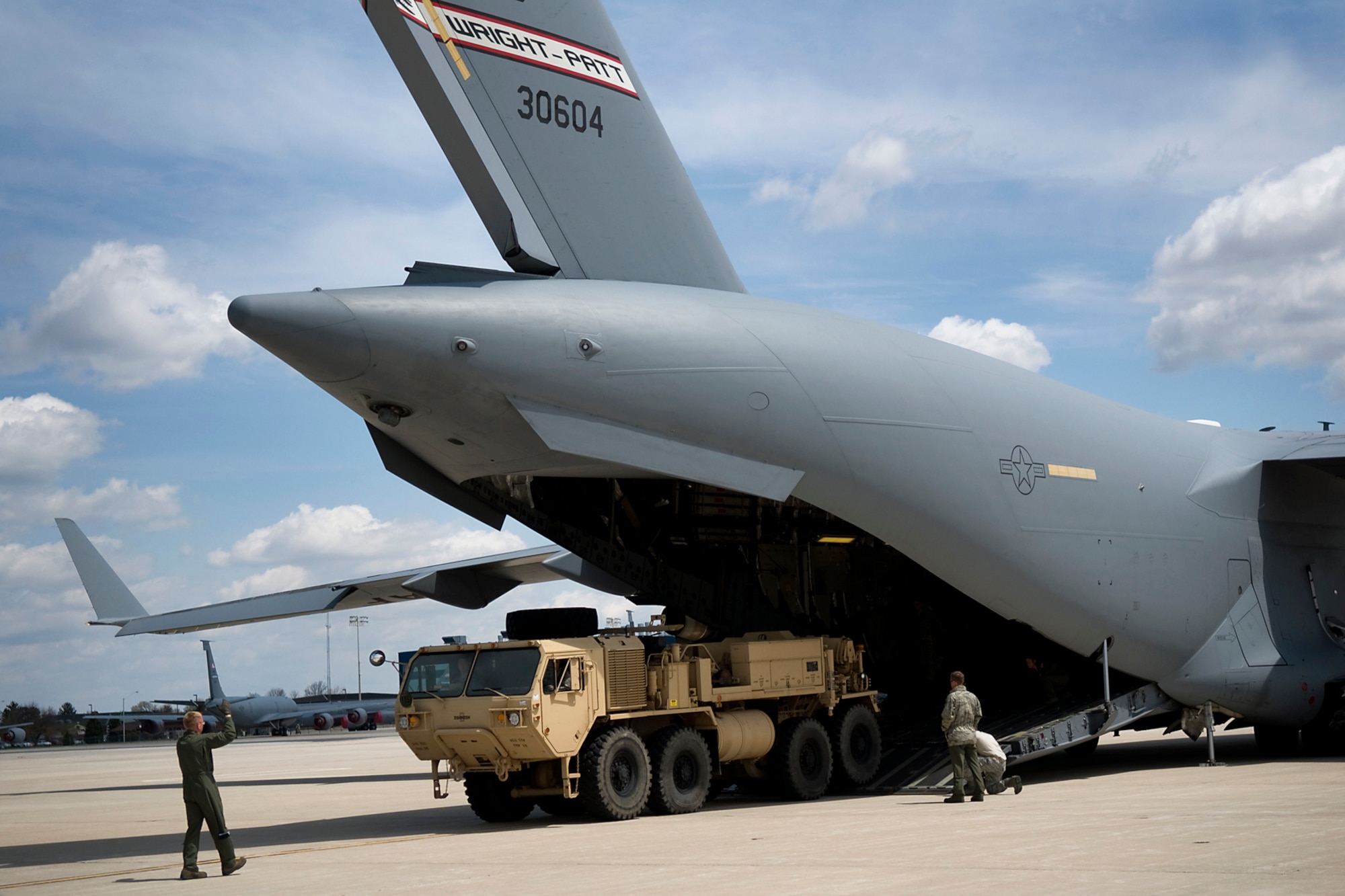 U.S. Air Force Master Sgt. David White, 89th Airlift Squadron loadmaster, directs Soldiers of the U.S. Army Reserve's 766th Transportation Battalion as they offload a heavy expanded mobility tactical truck from a C-17 Globemaster III aircraft at Grissom Air Reserve Base, Ind., May 3. 2014. Airmen of Grissom's 49th Aerial Port Squadron and Airmen from the 89th AS, based at Wright-Patterson Air Force Base, Ohio, took a day to show 766th BN Soldiers how to build cargo pallets for airlift and how to load a Humvee and a HEMTT into a C-17 Globemaster III aircraft. (U.S. Air Force photo/Tech. Sgt. Mark R. W. Orders-Woempner)
