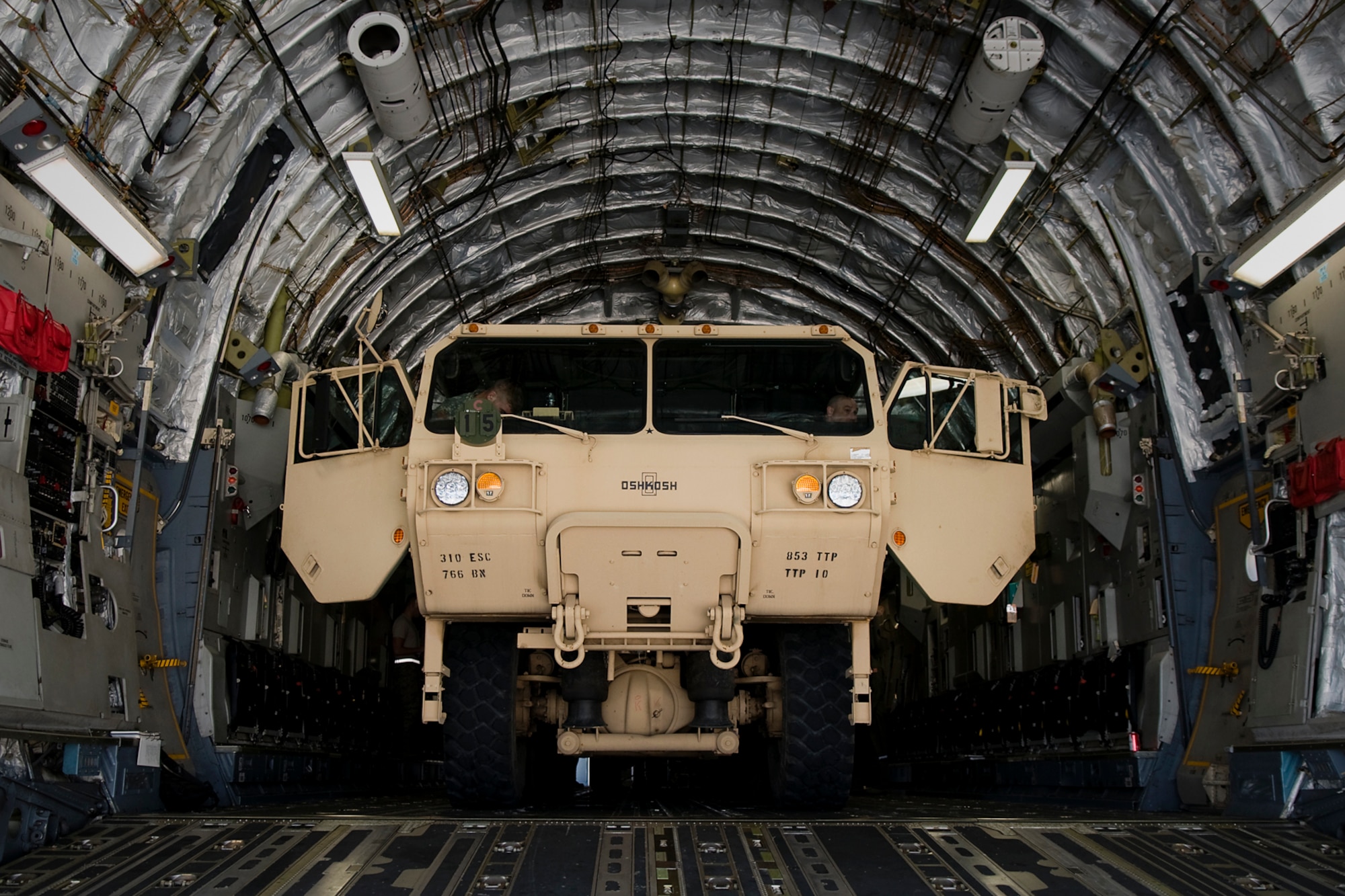 Soldiers of the U.S. Army Reserve's 766th Transportation Battalion train on loading a heavy expanded mobility tactical truck in a C-17 Globemaster III aircraft at Grissom Air Reserve Base, Ind., May 3. 2014. Airmen of Grissom's 49th Aerial Port Squadron and Airmen from the 89th AS, based at Wright-Patterson Air Force Base, Ohio, took a day to show 766th BN Soldiers how to build cargo pallets for airlift and how to load a Humvee and a HEMTT into a C-17 Globemaster III aircraft. (U.S. Air Force photo/Tech. Sgt. Mark R. W. Orders-Woempner)
