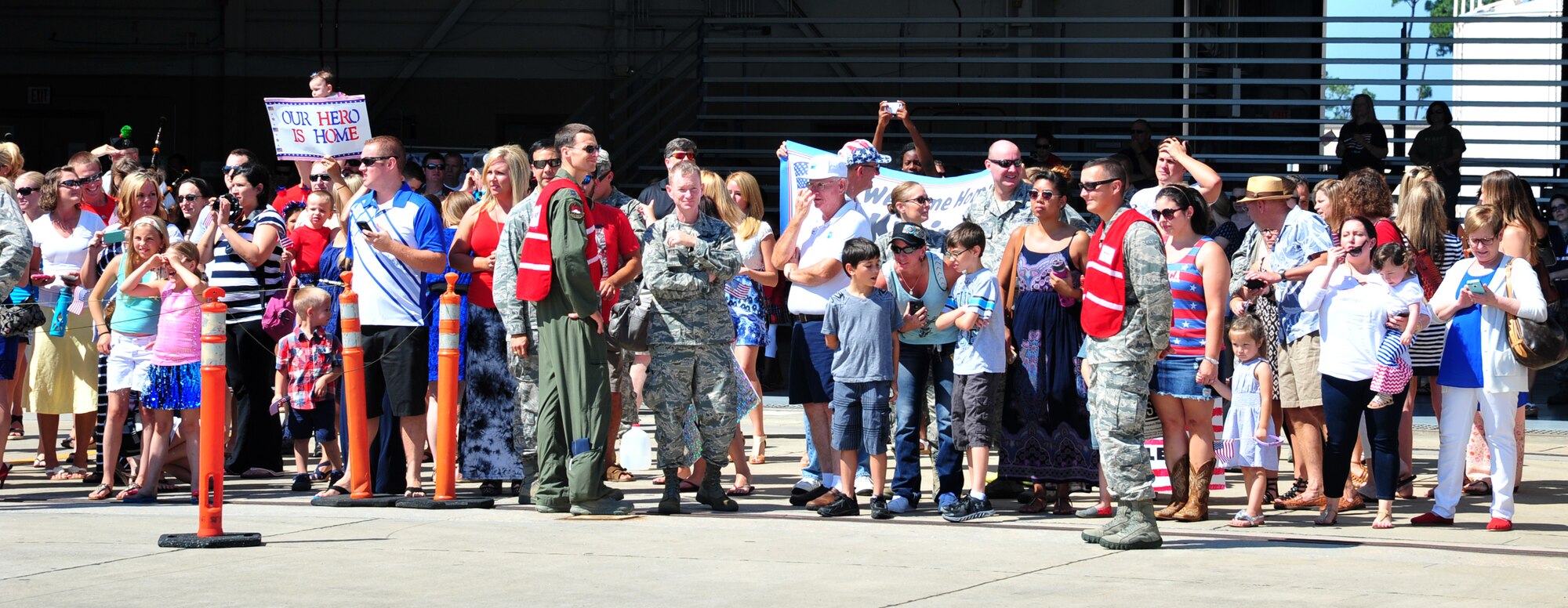 Family members and friends await the arrival of their loved ones during Operation Homecoming at Hurlburt Field, Fla., July 4, 2014. More than 150 Airmen returned from an overseas deployment. (U.S. Air Force photo/Senior Airman Desiree W. Moye)