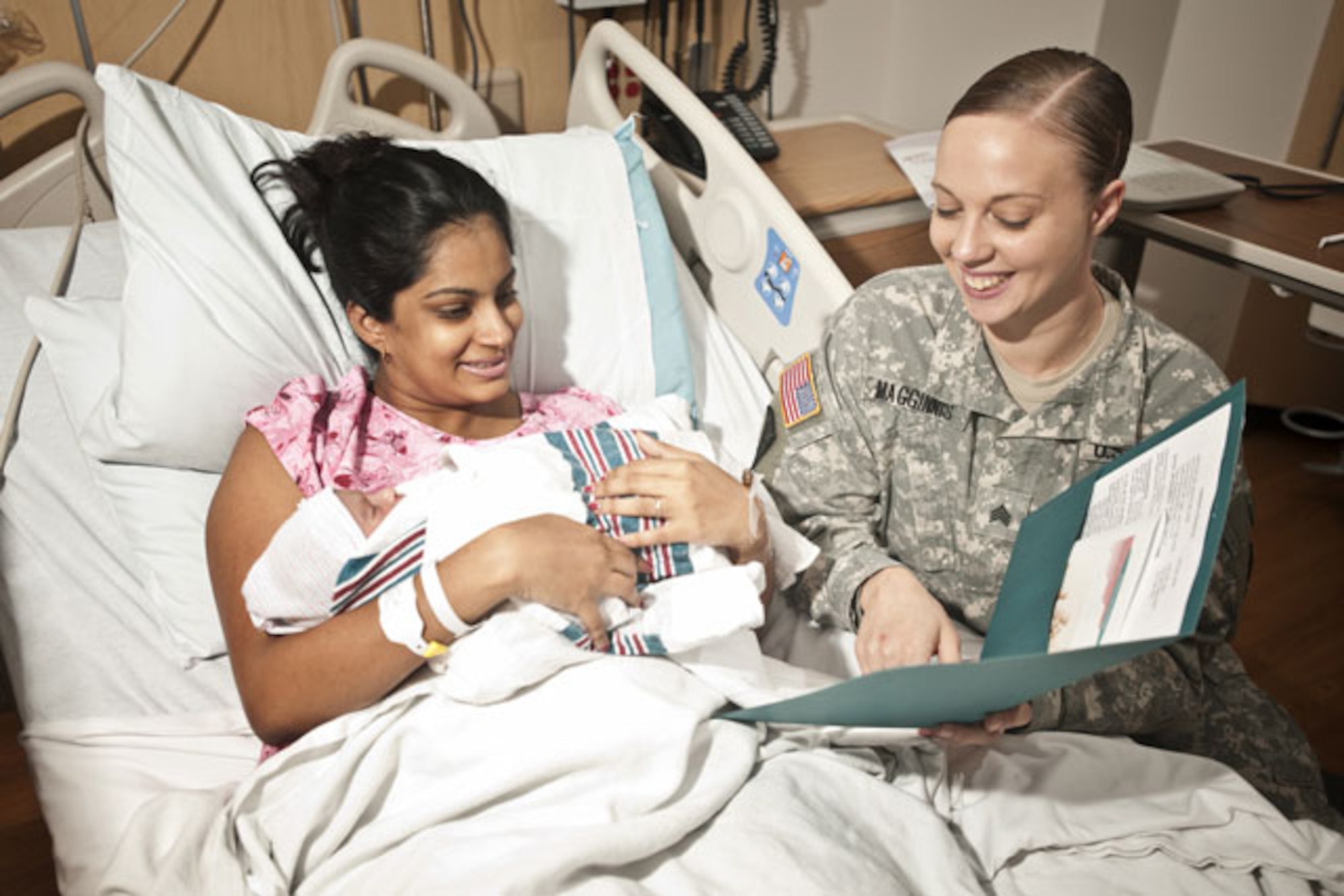 Sgt. Desiree Magginnis helps new mother, Amrita Thomas, learn how to best care for her newborn son, Ryan Thomas, in the Mother-Baby Unit at Fort Belvoir Community Hospital on July 27, 2012. (Army Photo by Tina Staffieri)