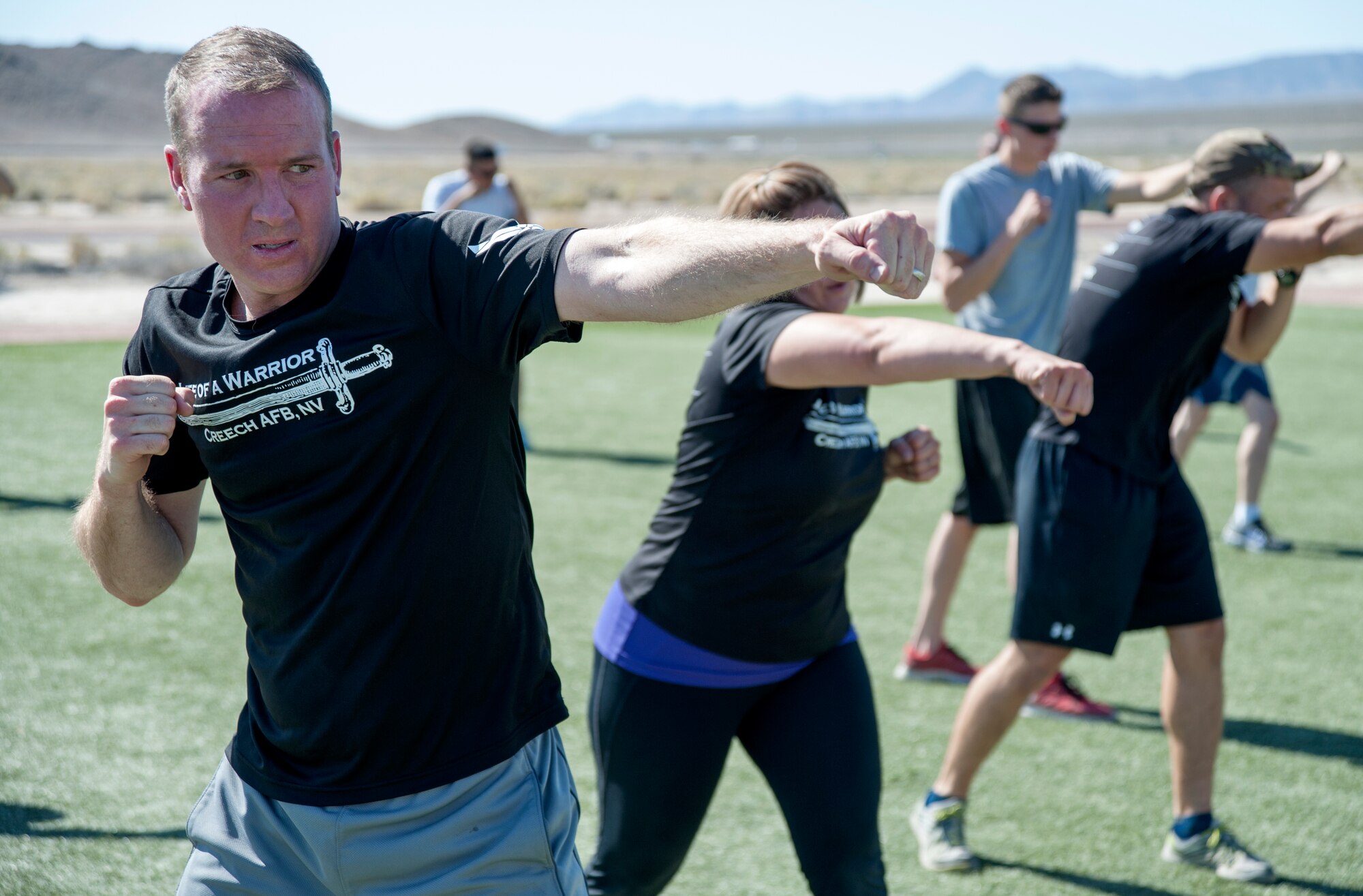 Maj. Randolph Witt, 799th Air Base Squadron commander, performs jabs during a Warrior Trained Fitness 3-minute boxing routine June 23, 2014, at Creech Air Force Base, Nev. Each month, the Life of a Warrior campaign hosts a specialty class designed to push the body to make big changes, while also encouraging participants to have fun with fellow warriors. (U.S. Air Force photo by Tech. Sgt. Shad Eidson/Released)