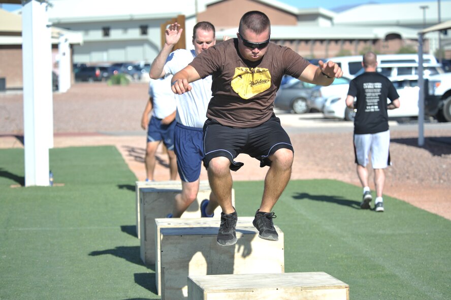 Senior Airman Brent Palmer, 799th Security Forces Squadron base alarm system administrator, jumps over boxes on an obstacle track during a Warrior Trained Fitness event June 23, 2014, at Creech Air Force Base, Nev. Each month the Life of a Warrior campaign hosts a specialty class designed to push the body to make big changes, while also encouraging participants to have fun with fellow warriors. (U.S. Air Force photo by Tech. Sgt. Shad Eidson/Released)