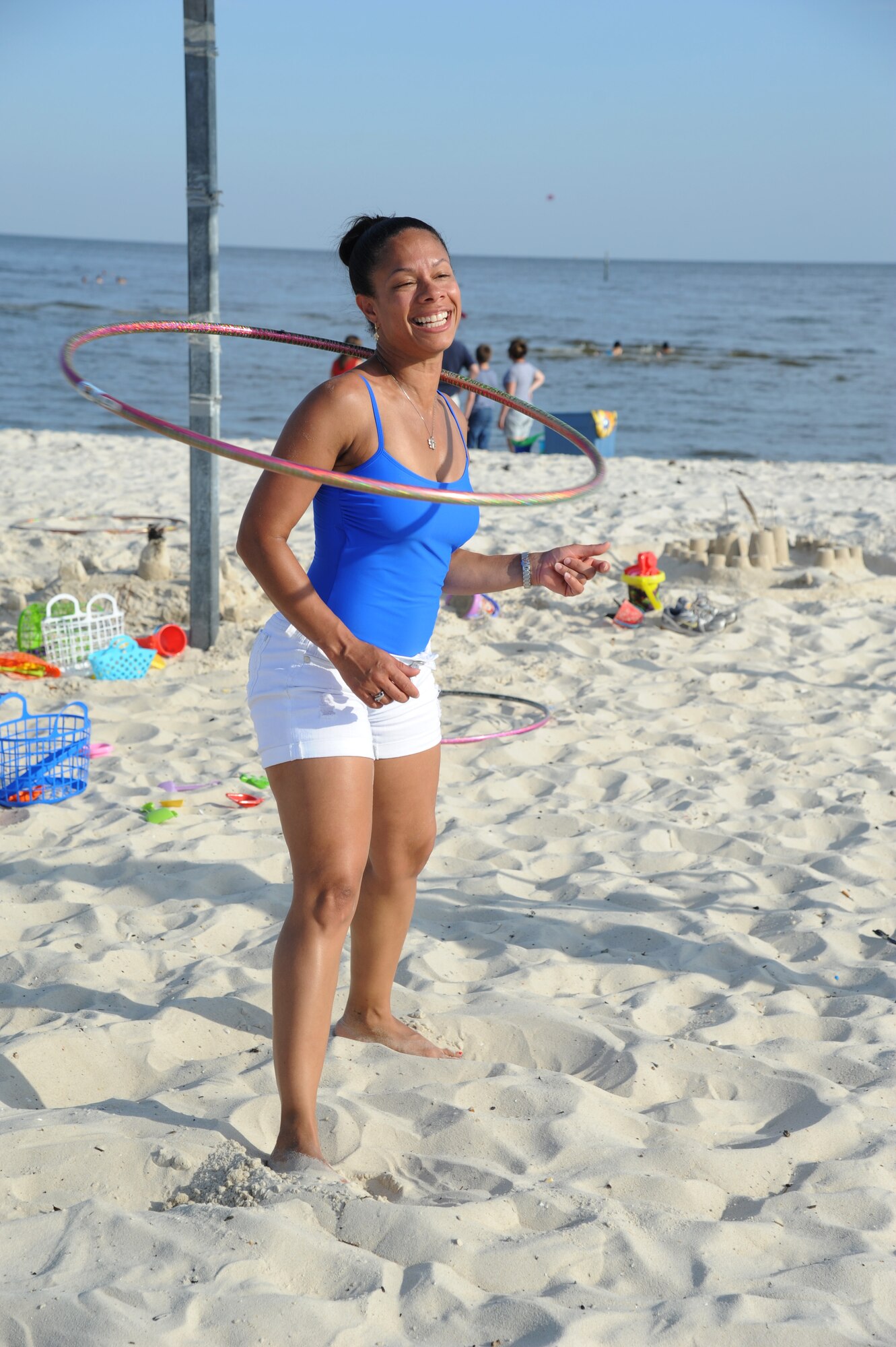 Master Sgt. Nicole Dismute, 81st Medical Support Squadron, spins a hula-hoop around her neck during Keesler’s 4th of July Beach Bash on Biloxi Beach, Miss.  The event included contests, music, games, food and fireworks.  (U.S. Air Force photo by Kemberly Groue)