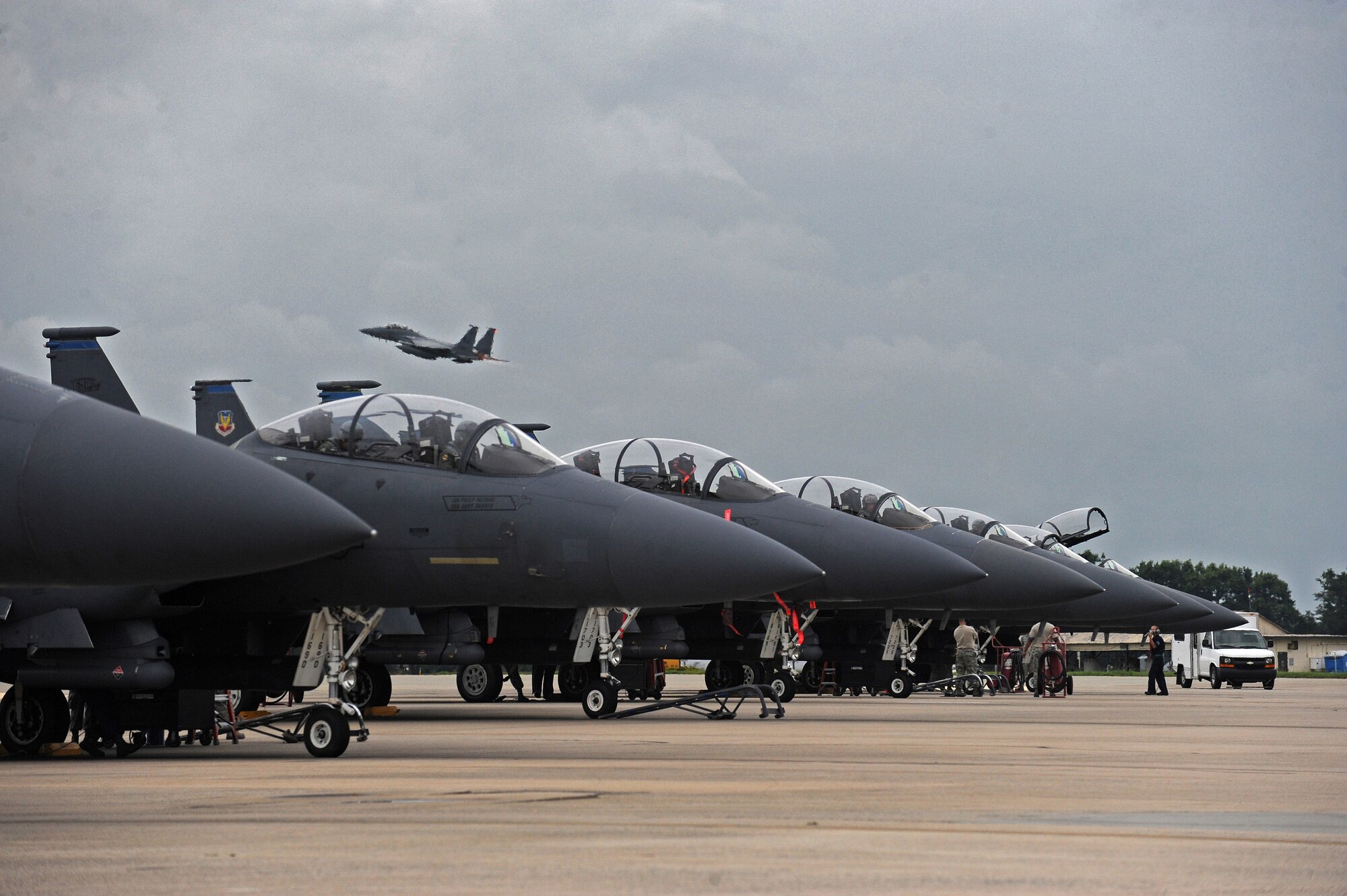 Airmen prepare a line of F-15E Strike Eagle aircraft to taxi July 3, 2014, at Seymour Johnson Air Force Base, N.C. More than 50 Strike Eagle aircraft were repositioned to Wright-Patterson Air Force Base, Ohio, as a precautionary measure to avoid potential damage from high winds associated with Hurricane Arthur. (U.S. Air Force photo/Airman 1st Class Aaron J. Jenne)