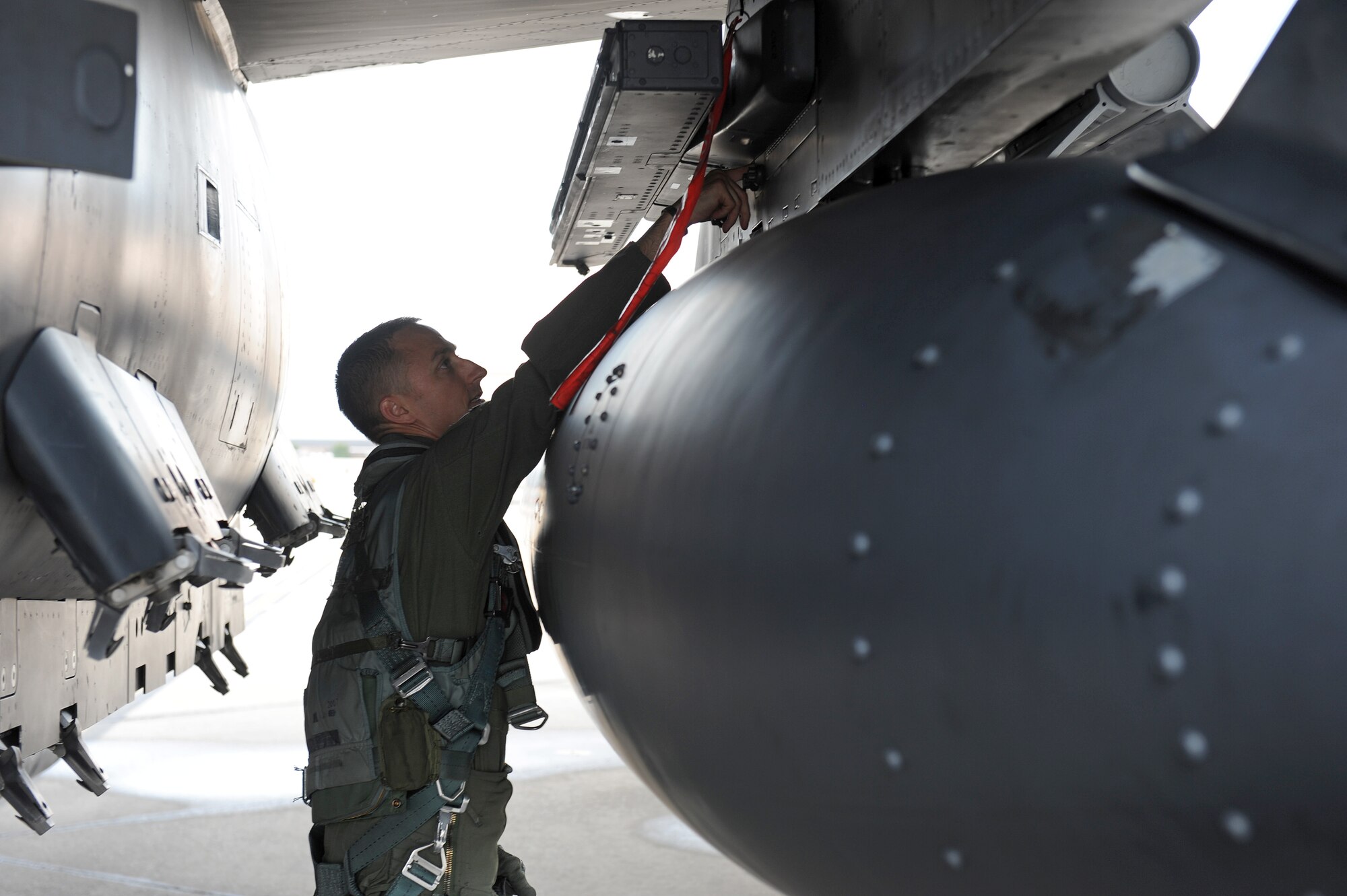 Maj. Michael Shields, 333rd Fighter Squadron weapon systems officer, performs a pre-flight inspection on his F-15E Strike Eagle, July 3, 2014, at Seymour Johnson Air Force Base, North Carolina. More than 50 Strike Eagle aircraft were repositioned to Wright-Patterson Air Force Base, Ohio, as a precautionary measure to avoid potential damage from high winds associated with Hurricane Arthur. (U.S. Air Force photo/Airman 1st Class Aaron J. Jenne)