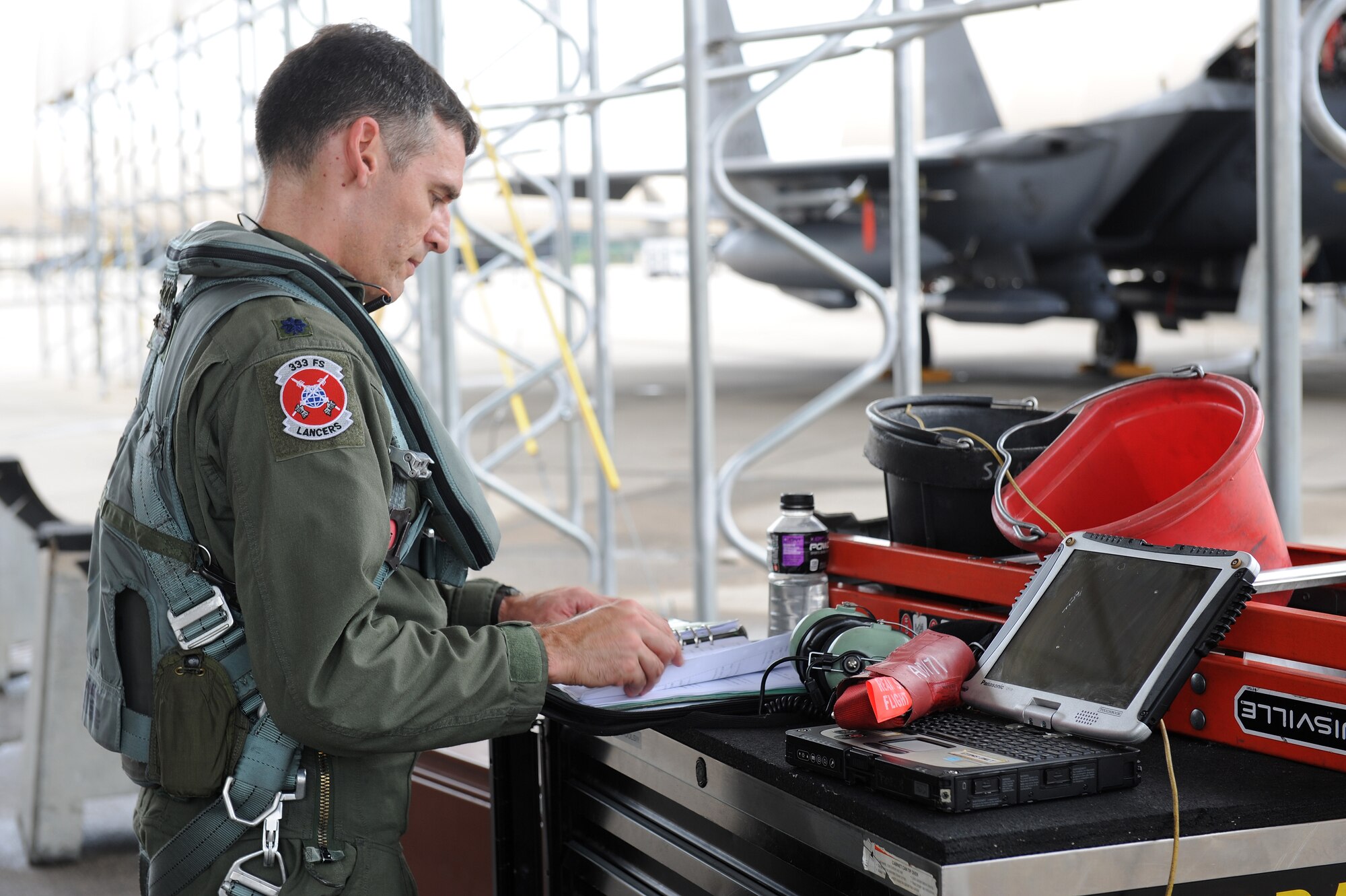 Lt. Col. Paul Hibbard, 333rd Fighter Squadron pilot, reviews a preflight checklist July 3, 2014, at Seymour Johnson Air Force Base, North Carolina. More than 50 Strike Eagle aircraft were repositioned to Wright-Patterson Air Force Base, Ohio, as a precautionary measure to avoid potential damage from high winds associated with Hurricane Arthur. (U.S. Air Force photo/Airman 1st Class Aaron J. Jenne)