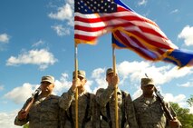 Members of the Minot Air Force Base Honor Guard present the colors during practice June 20, 2014. Color teams generally consist of four individuals. The colors are carried by the two Airmen in the middle, and are protected by the two rifle guards at either end of the formation. (U.S. Air Force photo/Senior Airman Brittany Y. Bateman)