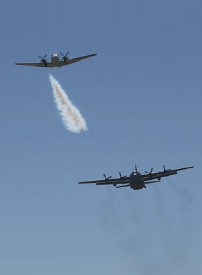 A U.S. Forest Service lead plane blows smoke to signal a Modular Airborne Fire Fighting System-equipped C-130 from the Wyoming Air National Guard's 153rd Airlift Wing that it’s time to drop its payload during annual MAFFS training, near Cheyenne, Wyo., on May 1, 2014. (Wyoming National Guard photo by Sgt. 1st Class Jimmy McGuire)

