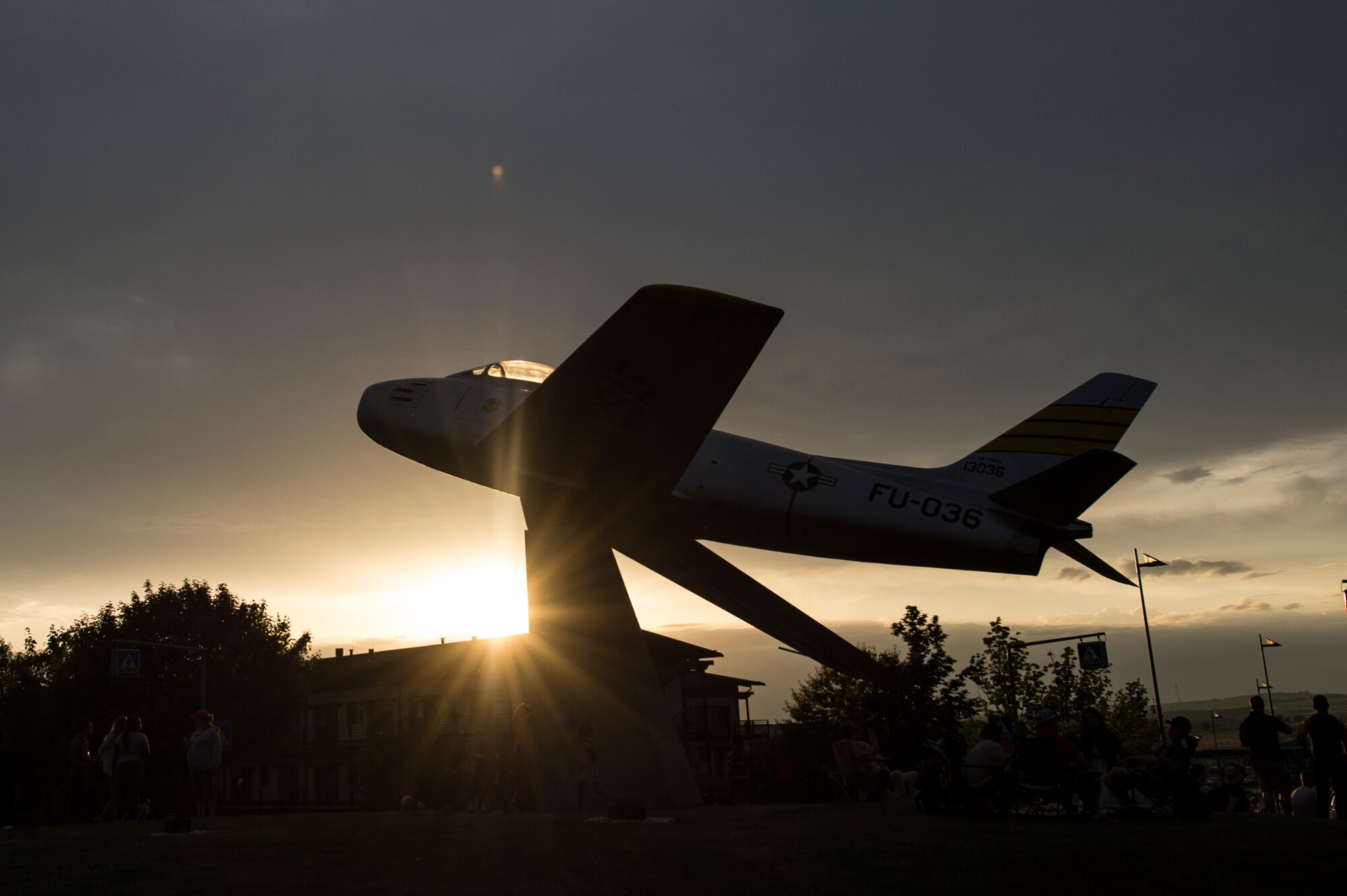 The sun sets during Super Saber Appreciation Day July 4, 2014, at Spangdahlem Air Base, Germany. During the event, families enjoyed swings, carousel rides, bouncy castles, pony rides, a dunk tank, a climbing wall and a fireworks display. (U.S. Air Force photo by Senior Airman Rusty Frank/Released)