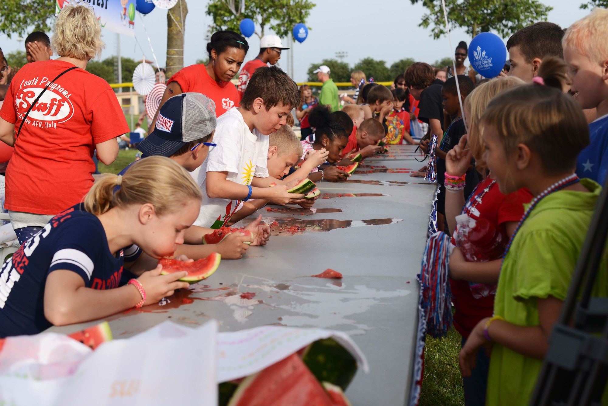 Children participant in a watermelon eating competition during the Fourth of July Celebration, July 4, 2014, at Aviano Air Base, Italy. The joint celebration gave Italians a unique opportunity to experience a little piece of America through food, community and celebrating our Independence Day.  (U.S Air Force photo/Airman 1st Class Deana Heitzman)  