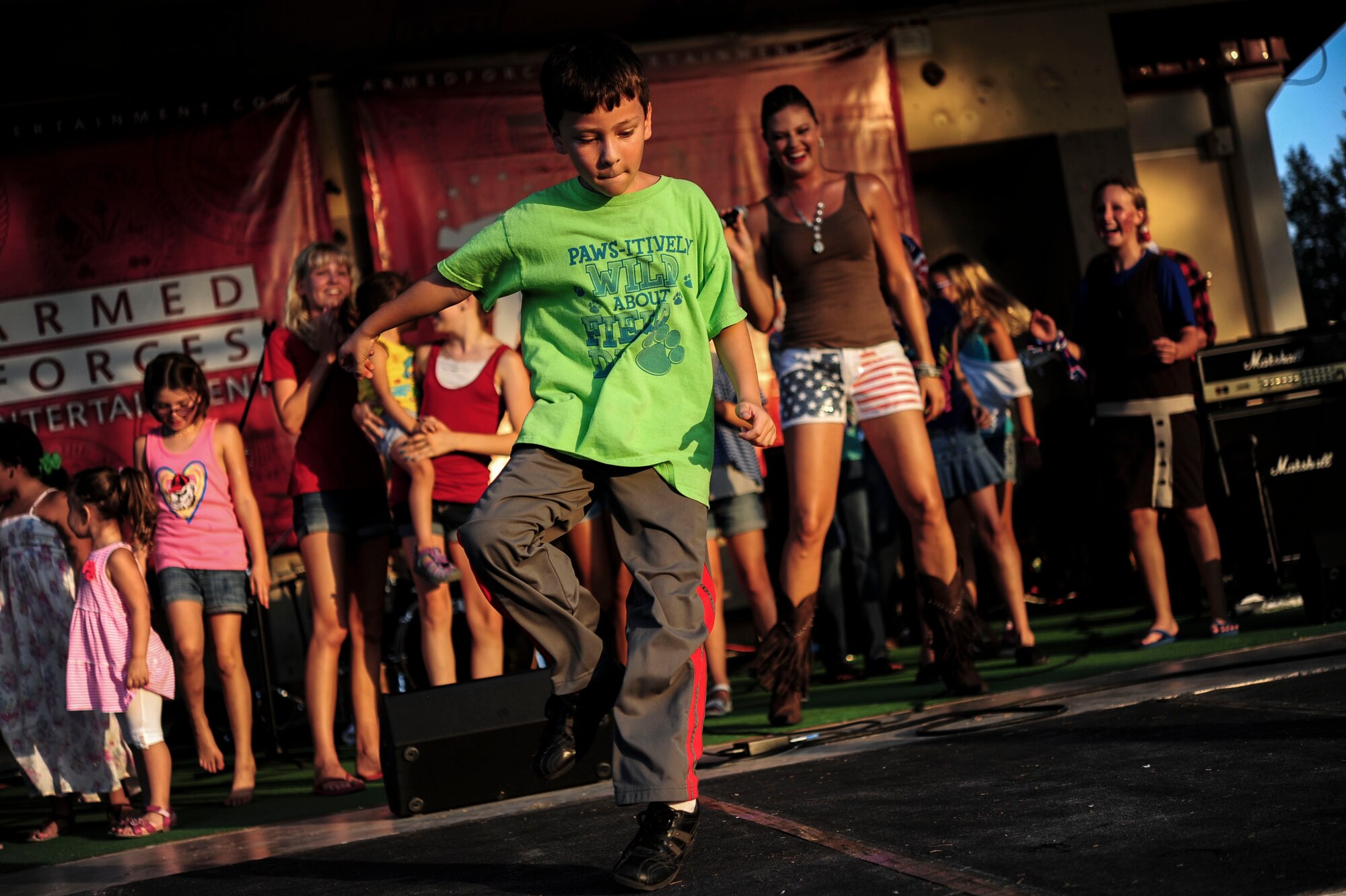 A child dances on stage during a musical performance by American Idol semifinalist Ayla Brown July 4, 2014,  Incirlik Air Base, Turkey.  The event, coordinated by the 39th Force Support Squadron, took more than 12 weeks of planning.   (U.S. Air Force photo by Senior Airman Nicole Sikorski/Released) 