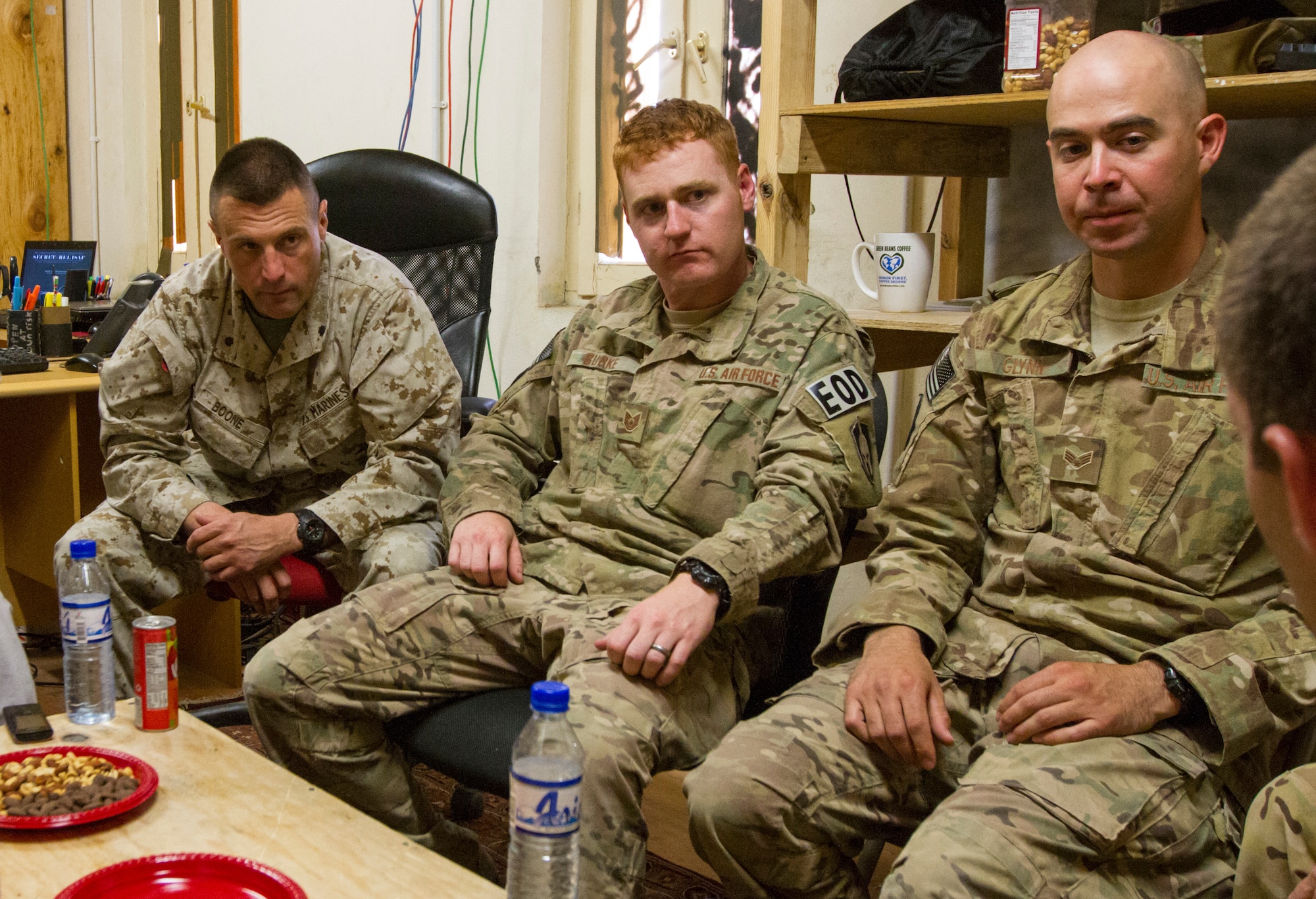 Marine Lt. Col. Mark Boone (left), team leader of Command International Security Assistance Force Advisory and Assistance Team-South, Air Force Tech Sgt. Adam Burke of Eglin Air Force Base, Fla., and Senior Airman Andrew Glynn of Minot AFB, N.D., listen to Dr. Carter Malkasian, senior political adviser to Gen. Joseph F. Dunford Jr., commanding general of ISAF, during a meeting with Afghan National Police 1st Lt. Abdullah (name changed for security considerations), officer in charge of explosive ordnance disposal and improvised explosive device defeat in Kandahar, on Forward Operating Base Walton, Afghanistan, June 19, 2014. (U.S. Army photo/Sgt. 1st Class Brock Jones)
