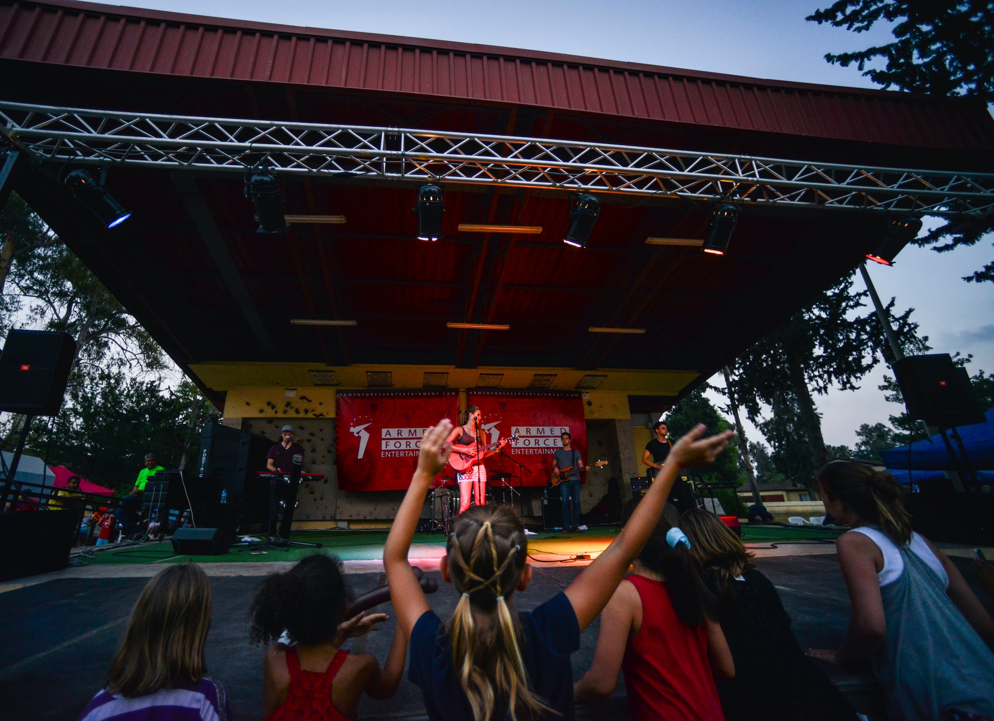 Children stand at the edge of the stage during a performance by American Idol semifinalist Ayla Brown  July 4, 2014,  Incirlik Air Base, Turkey.  The musical entertainment was presented by the Department of Defense’s Armed Forces Entertainment. (U.S. Air Force photo by Senior Airman Nicole Sikorski/Released)