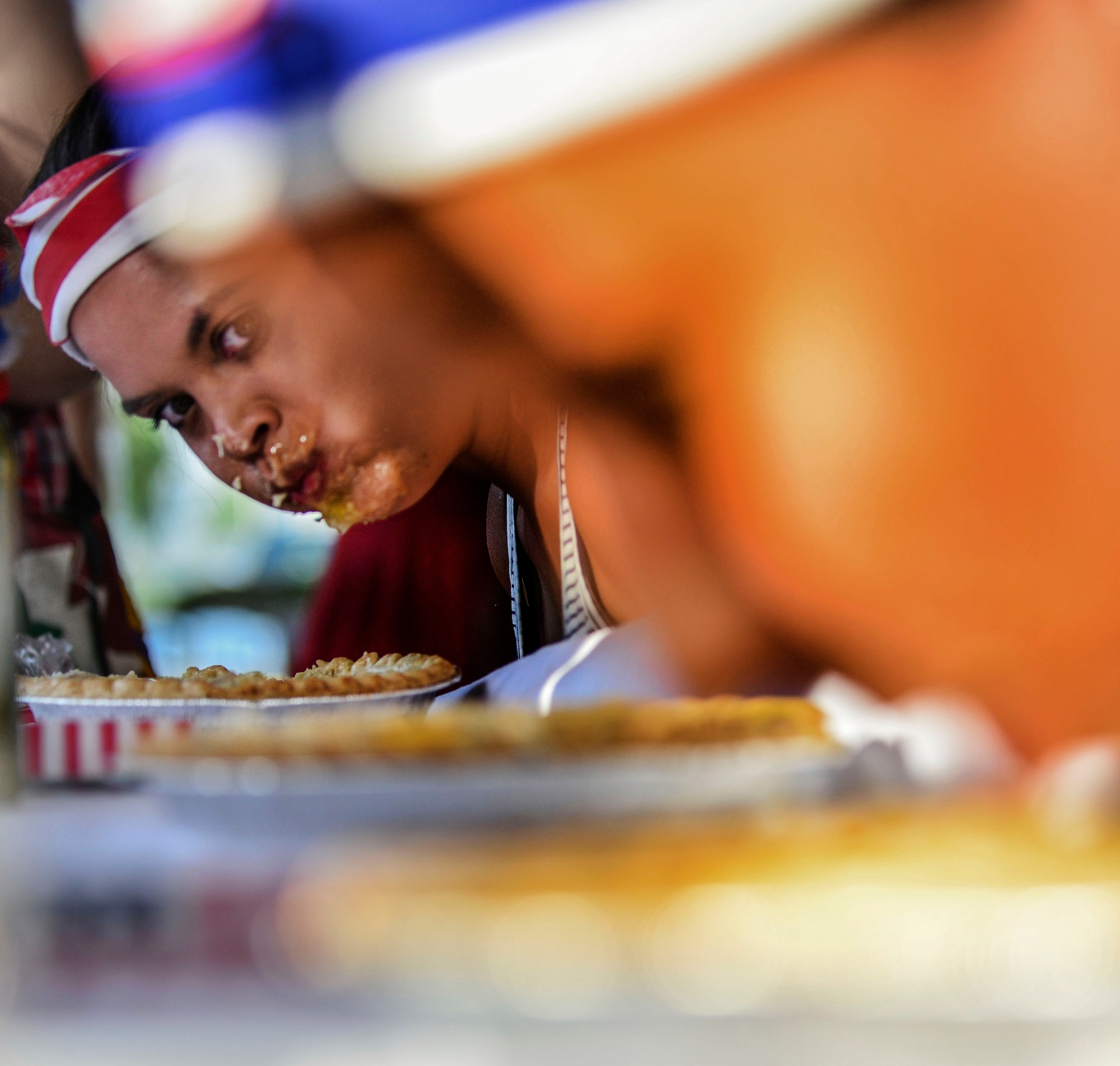 A contestant looks up at her opponents during a pie-eating contest at the Independence Day celebration July 4, 2014,  Incirlik Air Base, Turkey.  There were approximately 400 Airmen and family members in attendance at the event which had live entertainment, fireworks and food. (U.S. Air Force photo by Senior Airman Nicole Sikorski/Released) 