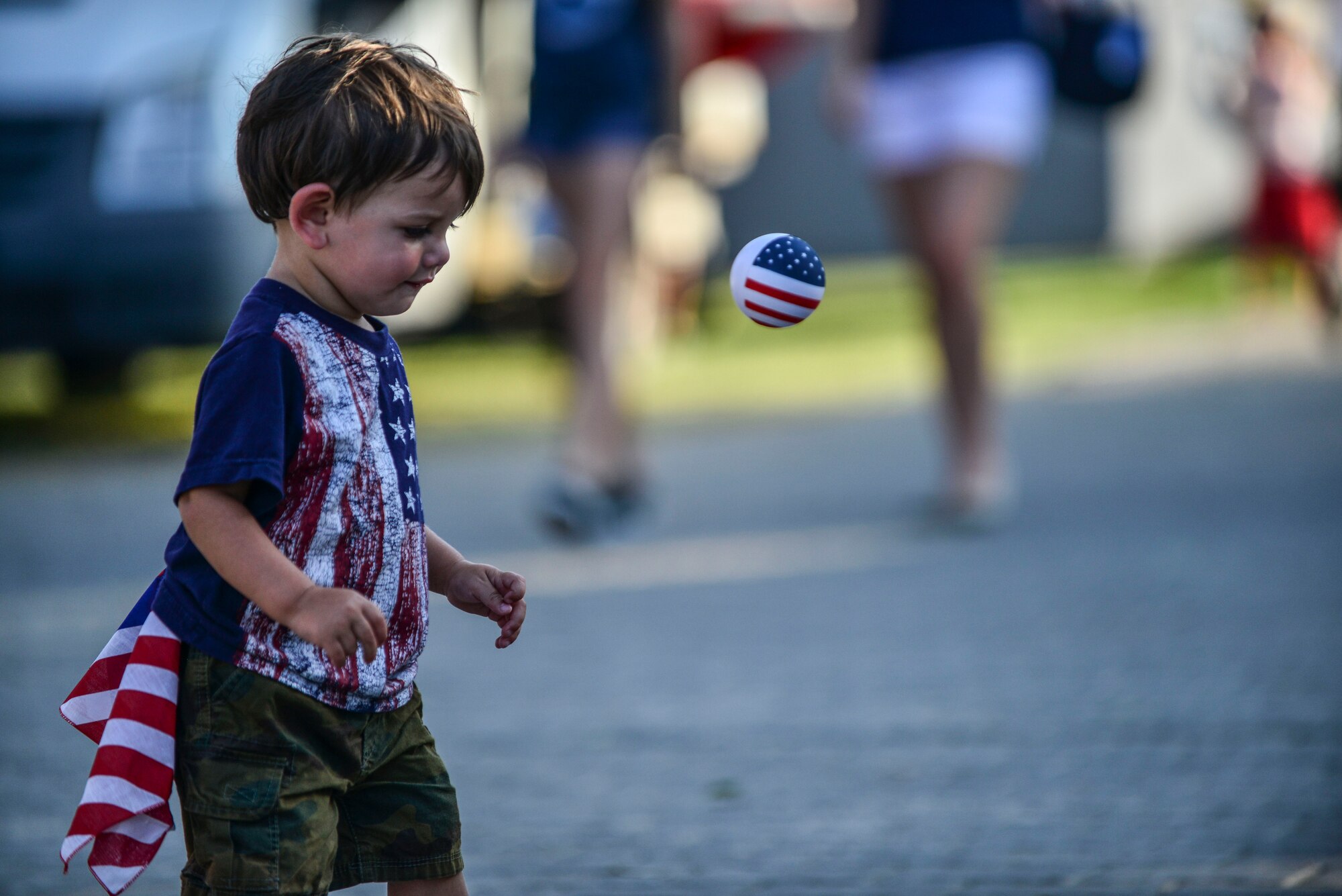 A child dressed in patriotic clothing chases a ball at the Independence Day celebration July 4, 2014,  Incirlik Air Base, Turkey.  The event had food, fireworks and activities for children, such as bouncy castles, games and face painting, kids had a chance to dance on stage with a special guest singer. (U.S. Air Force photo by Senior Airman Nicole Sikorski/Released) 
