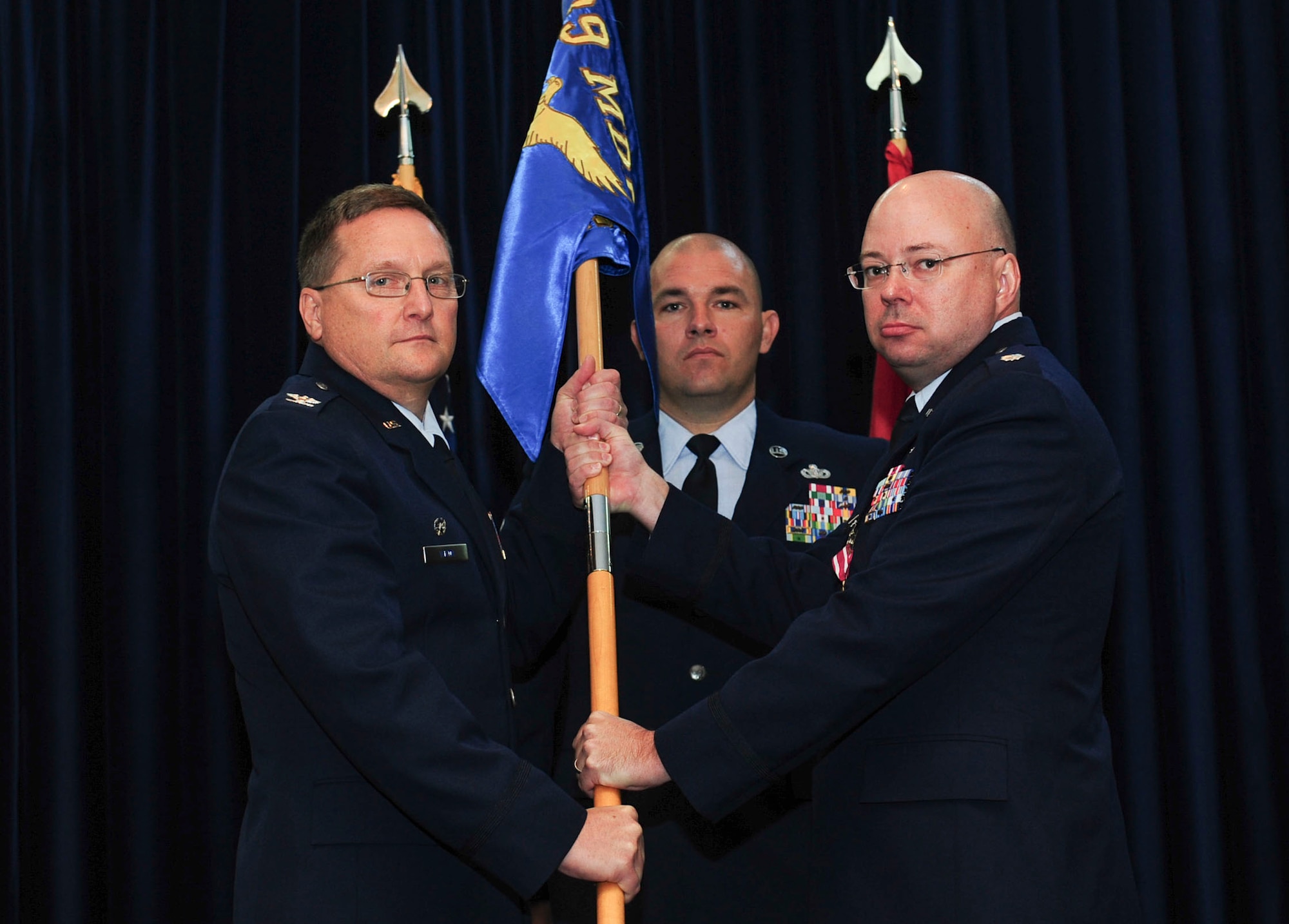 Col. Jerome Wizda, 39th Medical Group commander, receives the guidon from Lt. Col. Jonathan Richards, 39th Medical Support Squadron outgoing commander, during a change of command ceremony July 8, 2014, Incirlik Air Base, Turkey. The passing of the guidon symbolized the transfer of authority and responsibility from Lt. Col. Richards to Hooper. (U.S. Air Force photo by Senior Airman Nicole Sikorski/Released)  