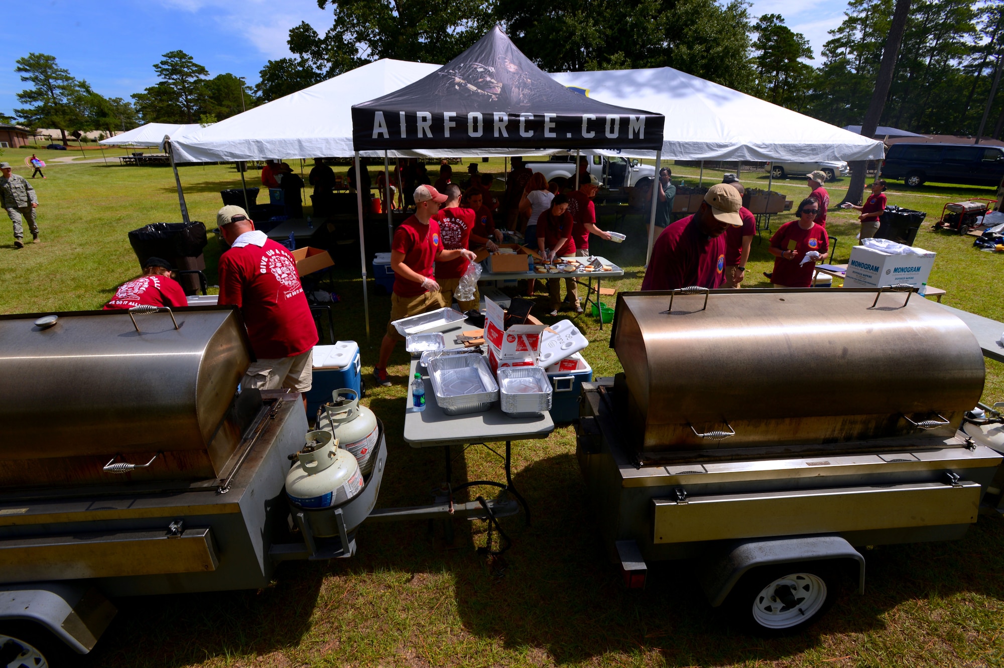 Airmen from the 20th Force Support Squadron cook and prepare hotdogs, hamburgers, and bratwursts in preparation for the 20th FSS Freedom Bash at Shaw Air Force Base, S.C., July 3, 2014. During the free event, Airmen and their families enjoyed food and fun to kick-off their Fourth of July weekend. (U.S. Air Force photo by Airman 1st Class Jensen Stidham/Released)