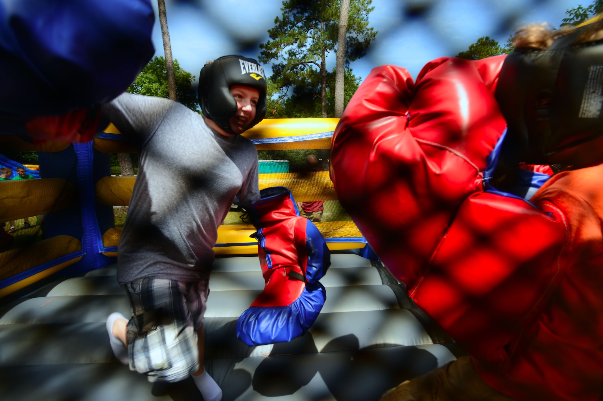 [From left] Ethan and Aiden Boarts, sons of Chaplain (Maj.) Matthew Boarts, 20th Fighter Wing interim wing chaplain, play in a bouncy boxing ring during the 20th Force Support Squadron Freedom Bash at Shaw Air Force Base, S.C., July 3, 2014. During the free event, Airmen and their families enjoyed food and fun to kick-off the Fourth of July weekend. (U.S. Air Force photo by Airman 1st Class Jensen Stidham/Released)