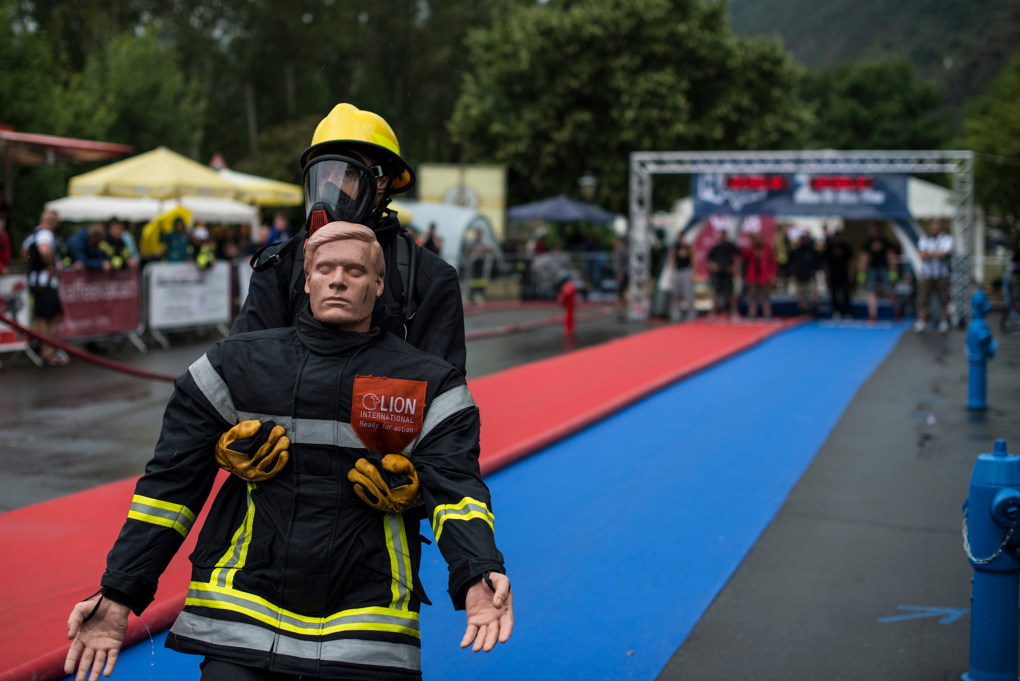 Roger Mead, Royal Air Force Alconbury, 423rd Civil Engineer Squadron firefighter, leads the race during the victim rescue obstacle during the first Mosel Firefighter Combat Challenge in Ediger-Eller, Germany, July 5, 2014. The victim rescue is the last obstacle of five requiring a firefighter to carry a 175-pound mannequin 30 meters to the finish line. (U.S. Air Force photo by Staff Sgt. Christopher Ruano/Released)