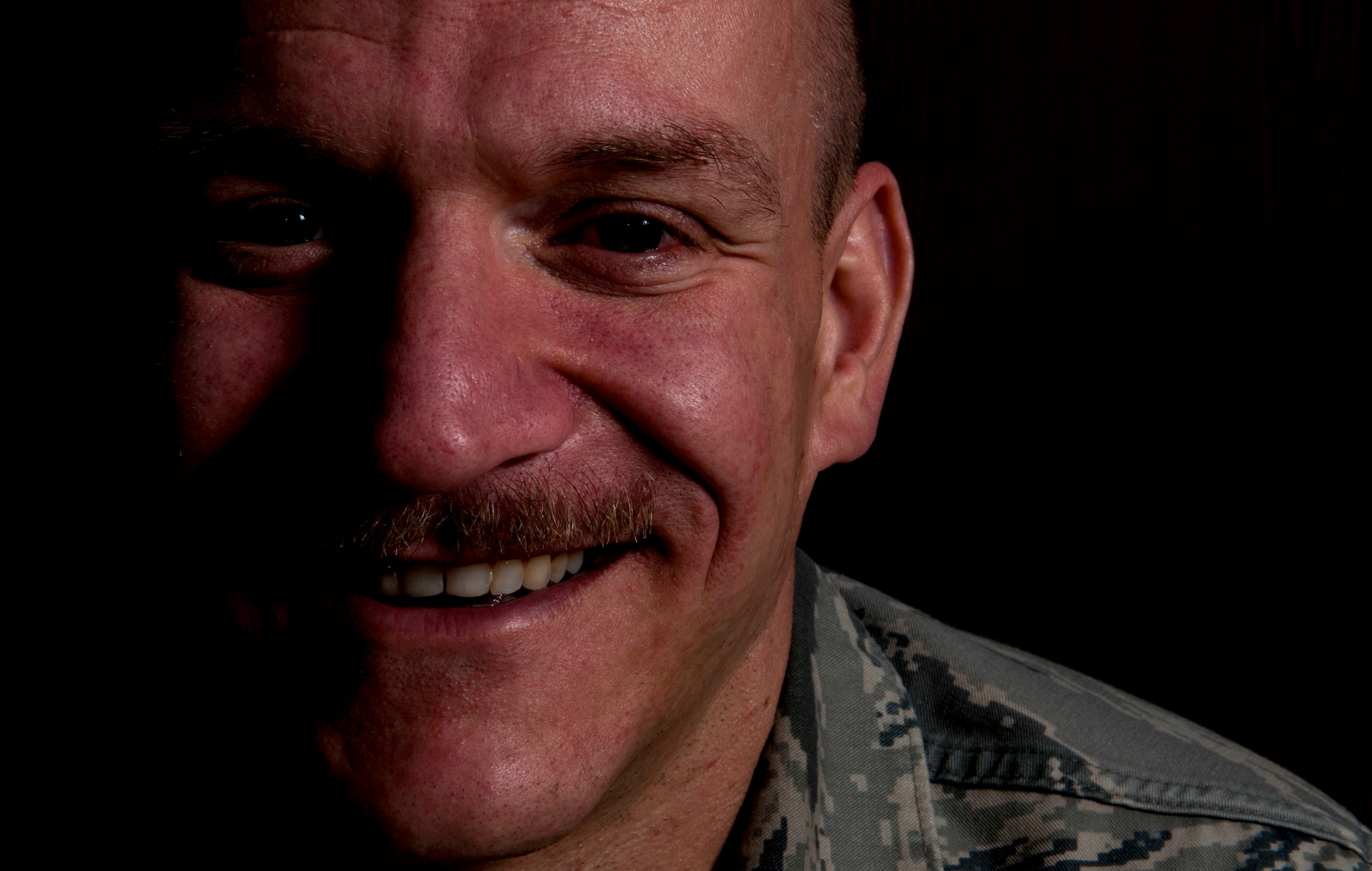 U.S. Air Force Master Sgt. Donald Stichter, 52nd Equipment Maintenance Squadron NCO in charge of munitions inspection from Lakewood, Colo., smiles for a portrait July 3, 2014, at Spangdahlem Air Base, Germany. To help train for the ING Luxembourg Night Marathon, Stichter used all four pillars of comprehensive fitness: mental, physical, spiritual, and social. (U.S. Air Force photo by Senior Airman Rusty Frank/Released)