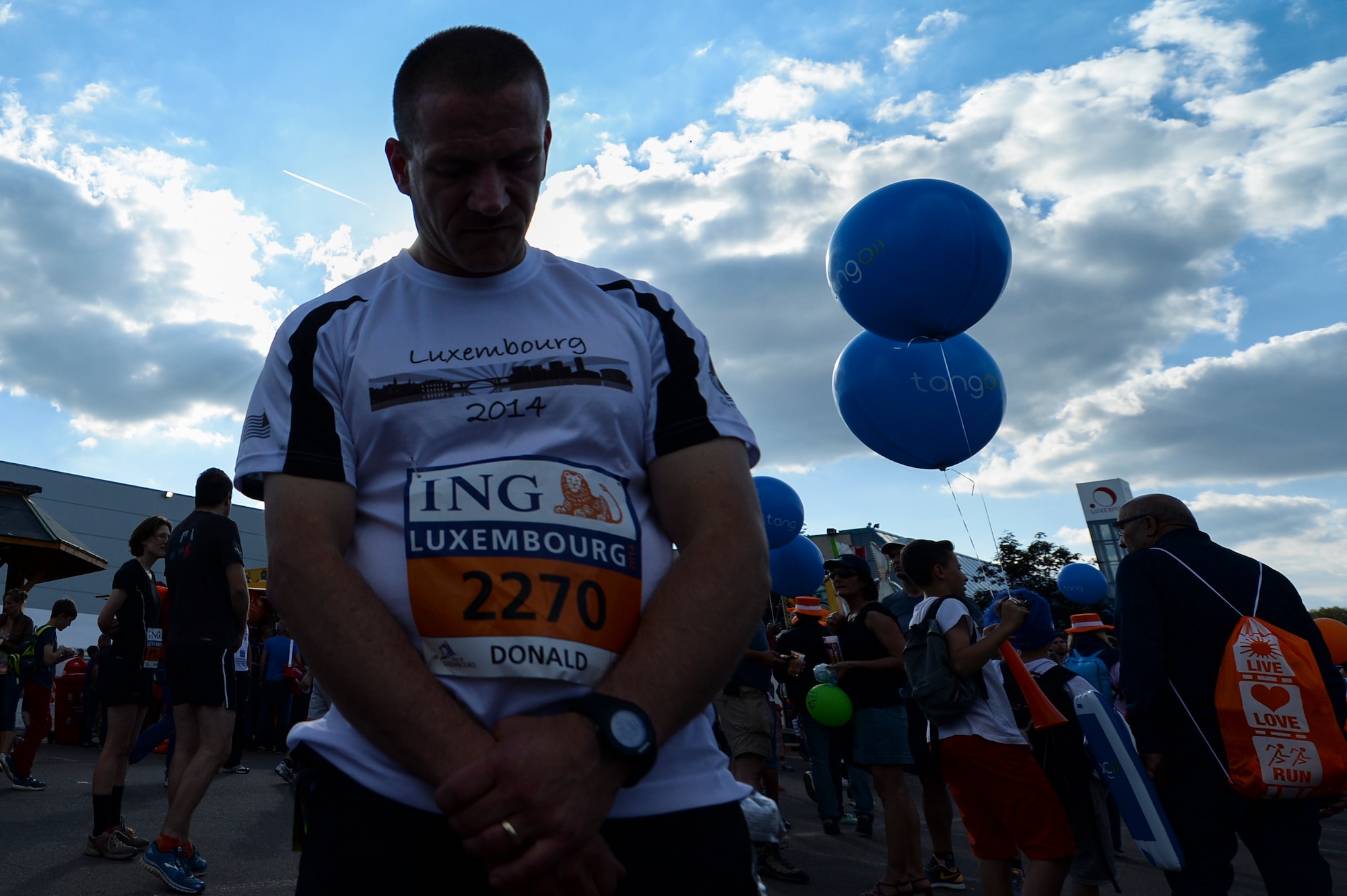 U.S. Air Force Master Sgt. Donald Stichter, 52nd Equipment Maintenance Squadron NCO in charge of munitions inspection, from Lakewood, Colo., prays right before running in the ING Luxembourg Night Marathon May 31, 2014, in Luxembourg. Comprehensive Airman Fitness is a holistic approach to develop over-arching Airman fitness and resilience. Its four pillars include physical, mental, spiritual and social aspects. (U.S. Air Force photo by Senior Airman Rusty Frank/Released)