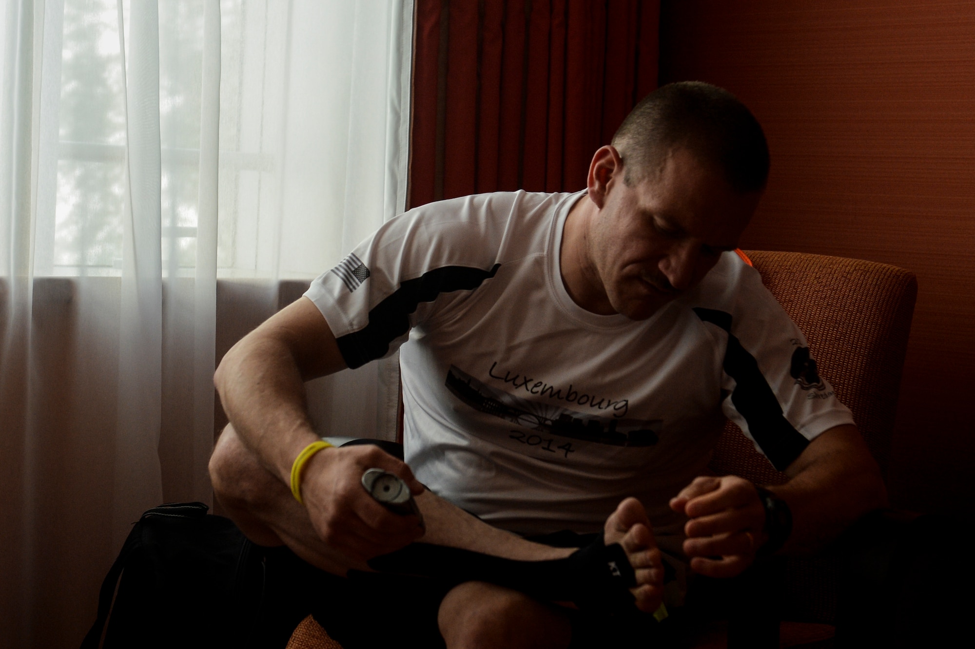 U.S. Air Force Master Sgt. Donald Stichter, 52nd Equipment Maintenance Squadron NCO in charge of munitions inspection from Lakewood, Colo., prepares his feet prior to the start of the ING Luxembourg Night Marathon May 31, 2014, in Luxembourg. Stichter trained for more than five months to get ready for the race. (U.S. Air Force photo by Senior Airman Rusty Frank/Released)