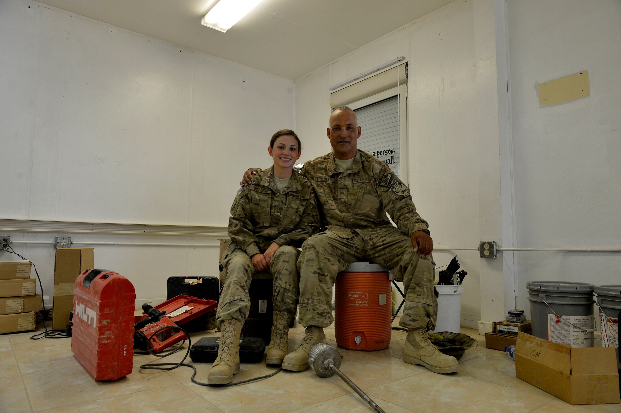 (From left) Staff Sgt. Kimberly Buzzell and Tech. Sgt. John Trujillo, pose for a photograph at Bagram Airfield, Afghanistan July 1, 2014. Trujillo and Buzzell are father and daughter, both assigned to Task Force Signal and deployed from the Air National Guard’s 243rd Engineering Installation Squadron in South Portland, Maine and natives of Turner, Maine.  Trujillo is a cable and antenna team chief while Buzzell is a radio frequency transmissions technician.  (U.S. Air Force photo by Staff Sgt. Evelyn Chavez/Released)