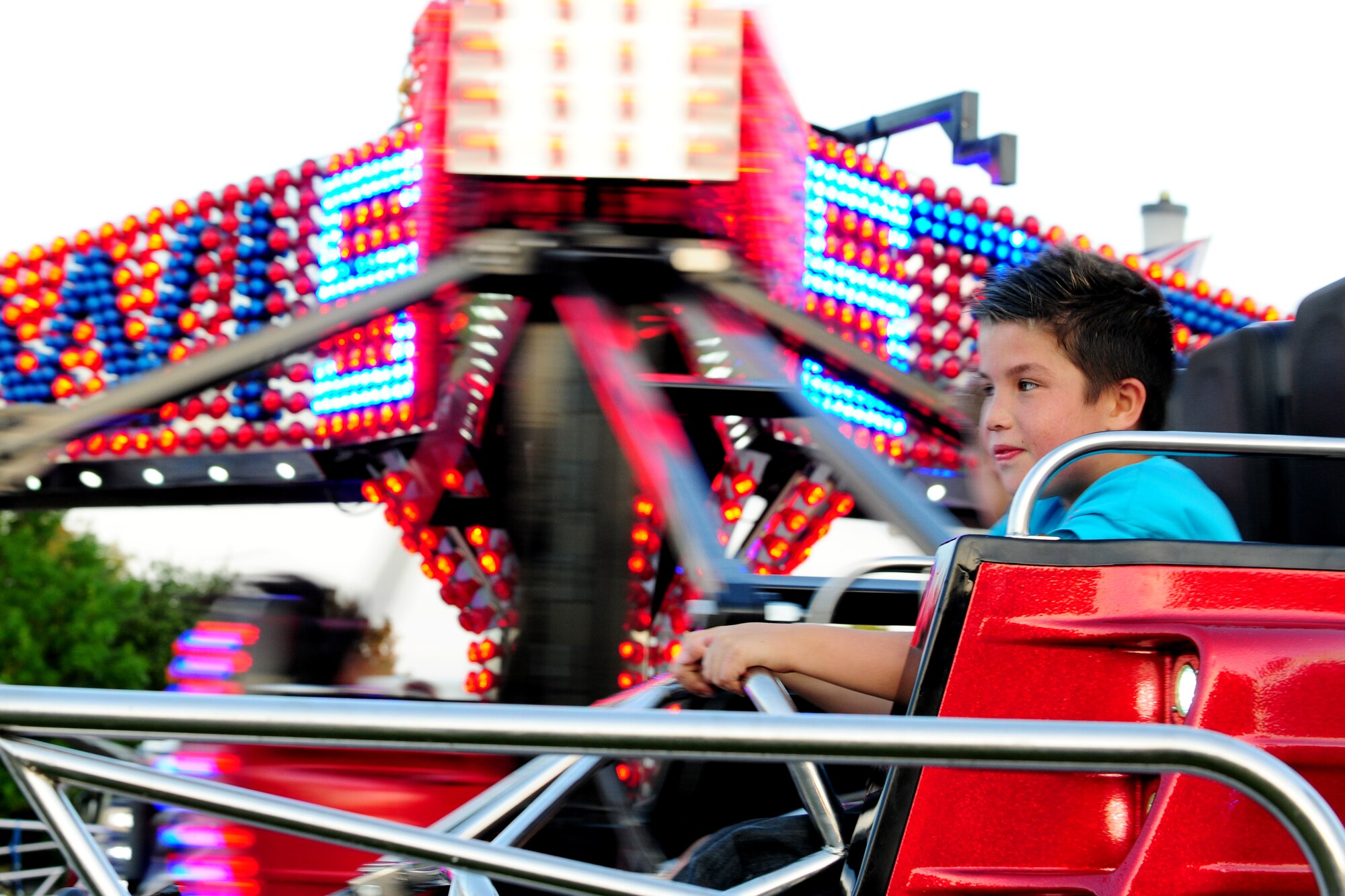 A young boy enjoys the “Twister” ride during the Fourth of July celebration at RAF Alconbury, United Kingdom, July 3, 2014. In addition to rides, children and adults were able to enjoy games, music and food. (U.S. Air Force photo by Staff Sgt. Jarad A. Denton/Released)