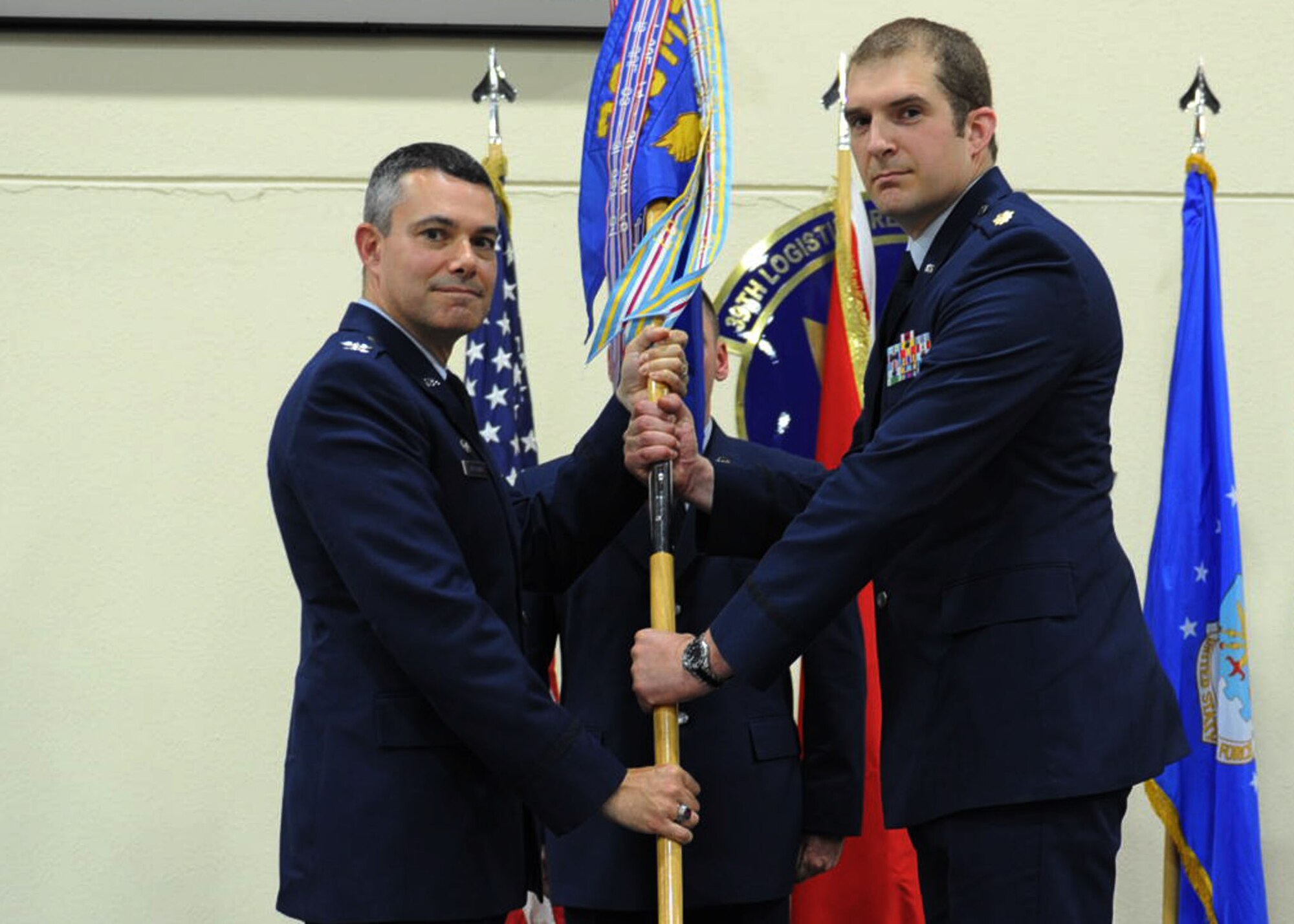 Col. Sean T. Gallagher, 39th Mission Support Group commander, passes the guidon to Maj. Daniel Nigolian during the 39th Logistics Readiness Squadron change of command ceremony June 12, 2014, Incirlik Air Base, Turkey. The ceremony signified the transition of command from Lt. Col. Gherdovich to Nigolian. (U.S. Air Force photo by Staff Sgt. Eboni Reams/Released)