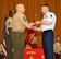 Master Sgt. Joseph P. Connolly, 731st Air Mobility Squadron passenger services section chief, receives his U.S. Marine Corps Staff NCO Academy diploma from USMC Sgt. Maj. Jerry L. Bates, Headquarters and Service Battalion, Marine Corps Base, Camp Smedly D. Butler senior enlisted advisor, during Class 14-4’s graduation at Camp Hansen, Japan, June 13, 2014. Connolly graduated from the advanced course that provides Marines and specially selected Airmen with the knowledge and skills necessary to assume leadership roles of greater responsibilty. (U.S. Air Force photo/Naoto Anazawa)