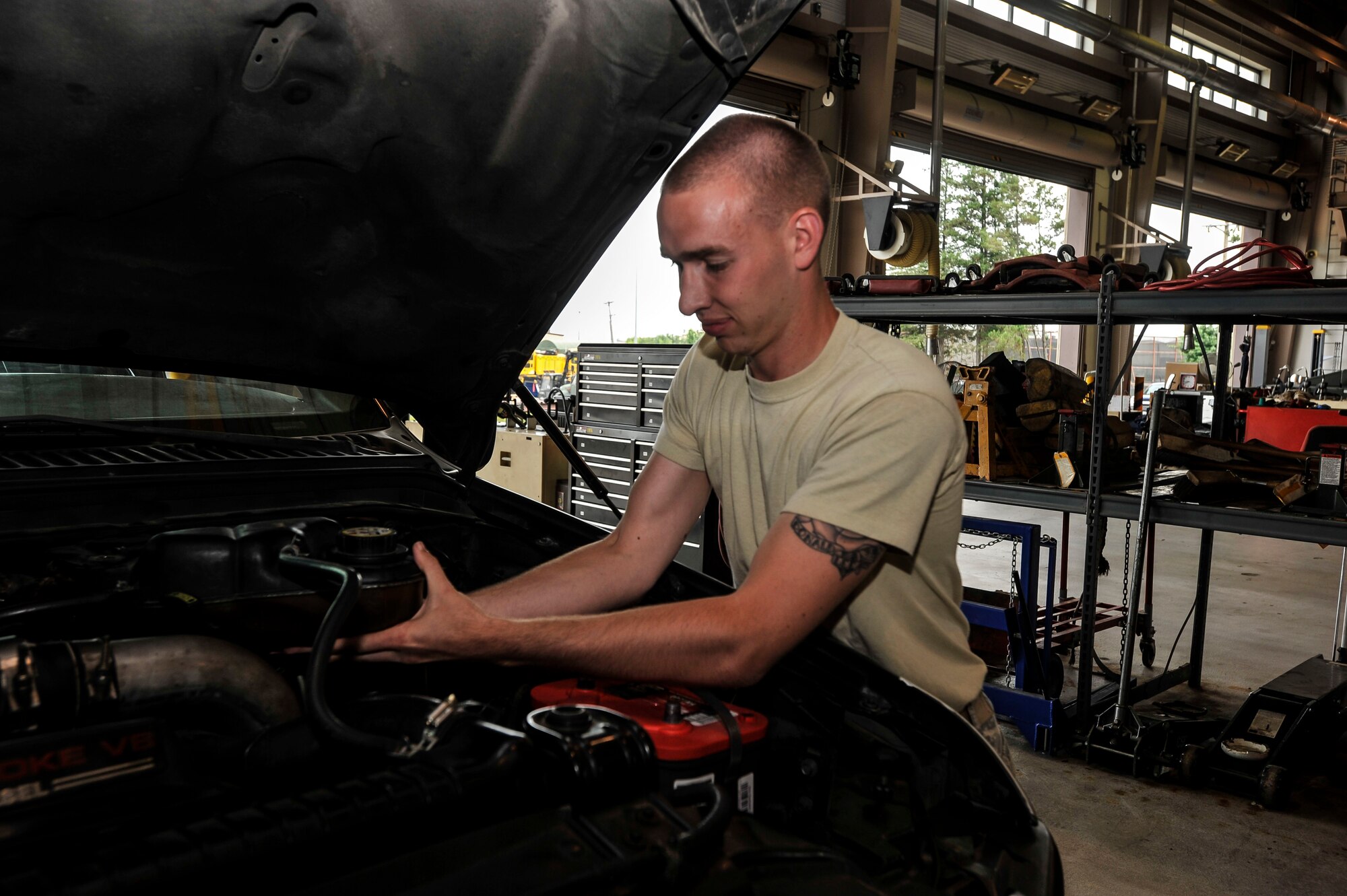 Airman 1st Class Jordan Luckstead, 51st Logistic Readiness Squadron materiel handling equipment maintenance journeyman, installs the radiator coolant overflow container on a vehicle on Osan Air Base, Republic of Korea, July 8, 2014. Luckstead is this week’s Airman Spotlight winner. (U.S. Air Force photo/Senior Airman David Owsianka)