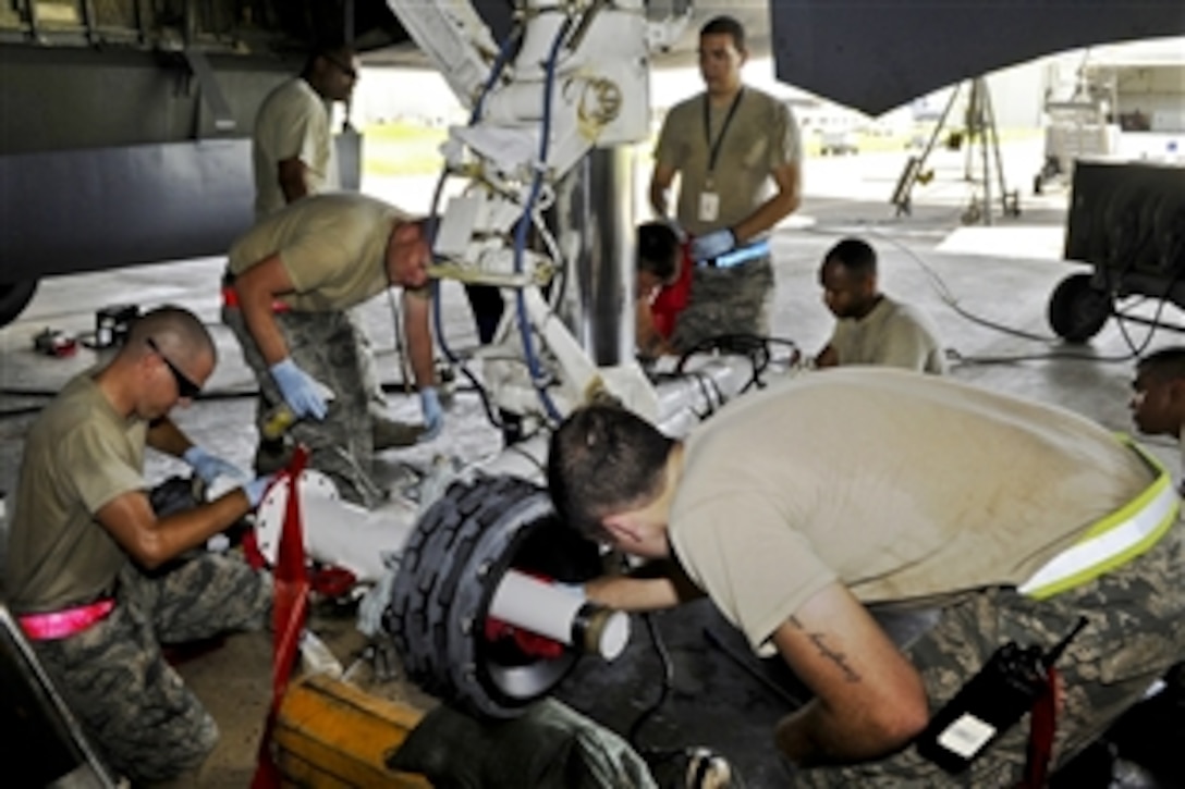 U.S. crew members service a KC-135 Stratotanker on Kadena Air Base, Japan, July 6, 2014, to prepare to move it off of Okinawa in advance of a massive typhoon expected to hit the island. The crew is assigned to the 718th Aircraft Maintenance Squadron.