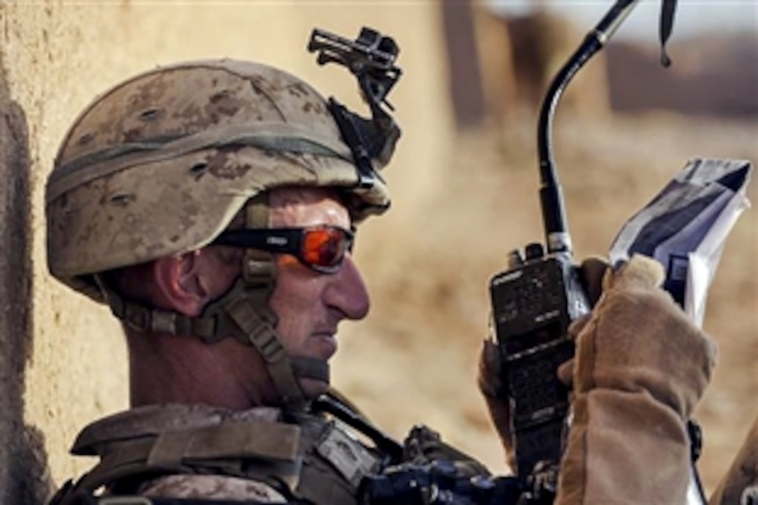 U.S. Marine Corps 1st Lt. Allen G. Frymire reports a position over a PRC-152 radio during an operation in Helmand province, Afghanistan, June 28, 2014. Frymire is a platoon commander assigned to 2nd Platoon, Charlie Company, 1st Battalion, 2nd Marine Regiment. Such reports allow other ground and air units to know troop locations during combat operations. 